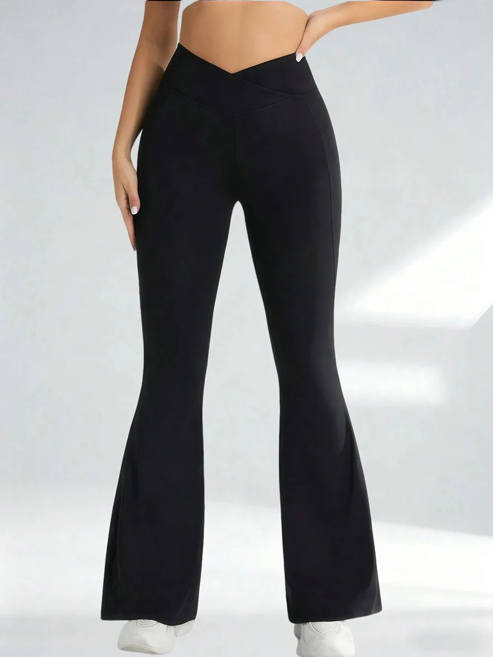 Crossover Flare Yoga Pants in Black, worn by a model