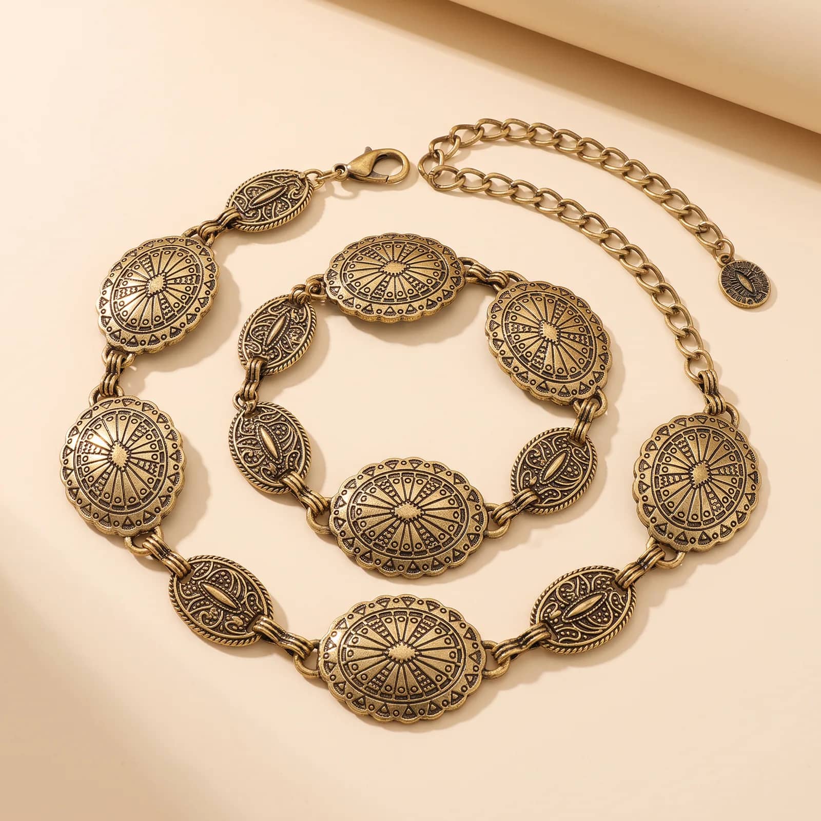 Western Concho Chain Belt in Antique Gold on a cream studio background