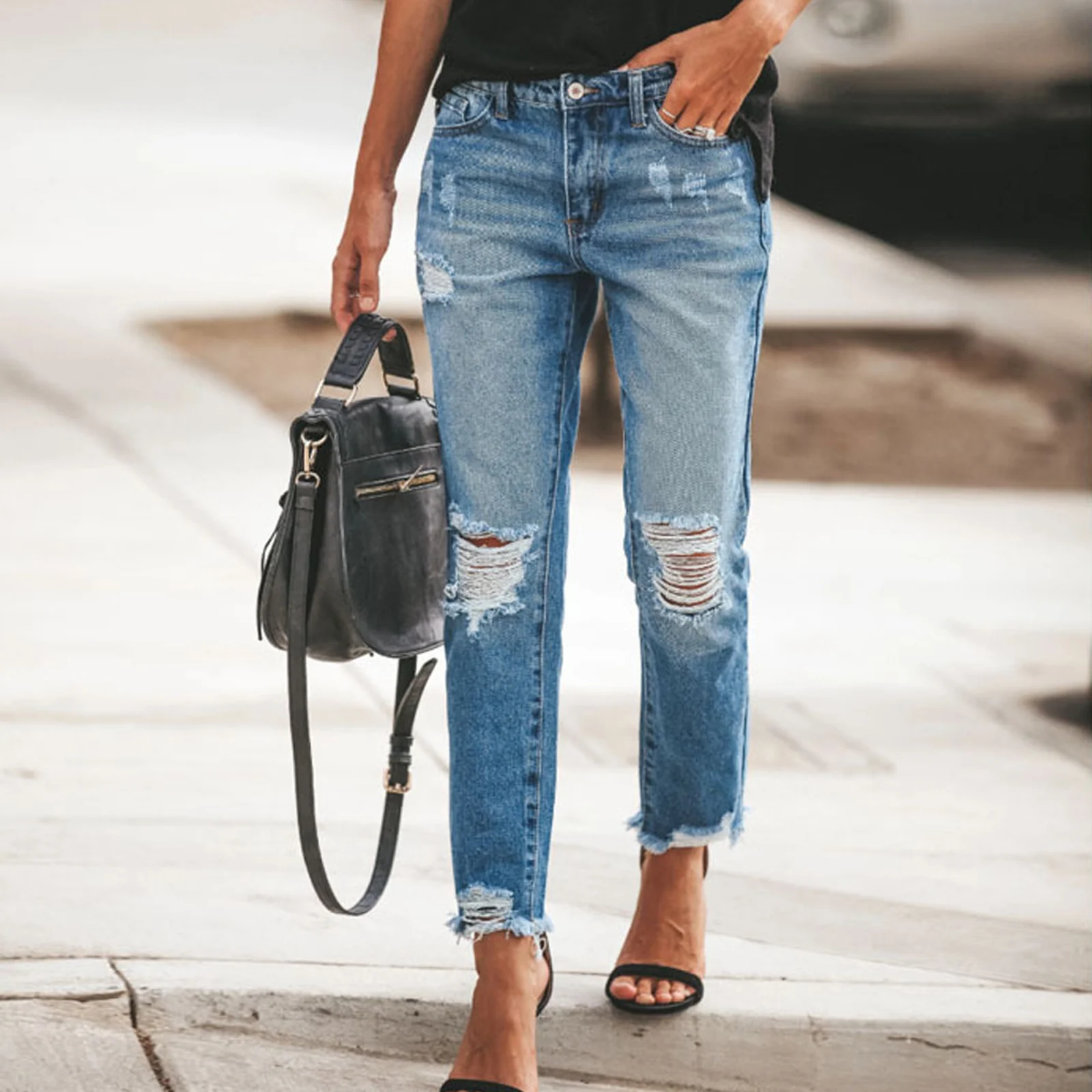 The Light Wash distressed jeans from the front, knee rips visible
