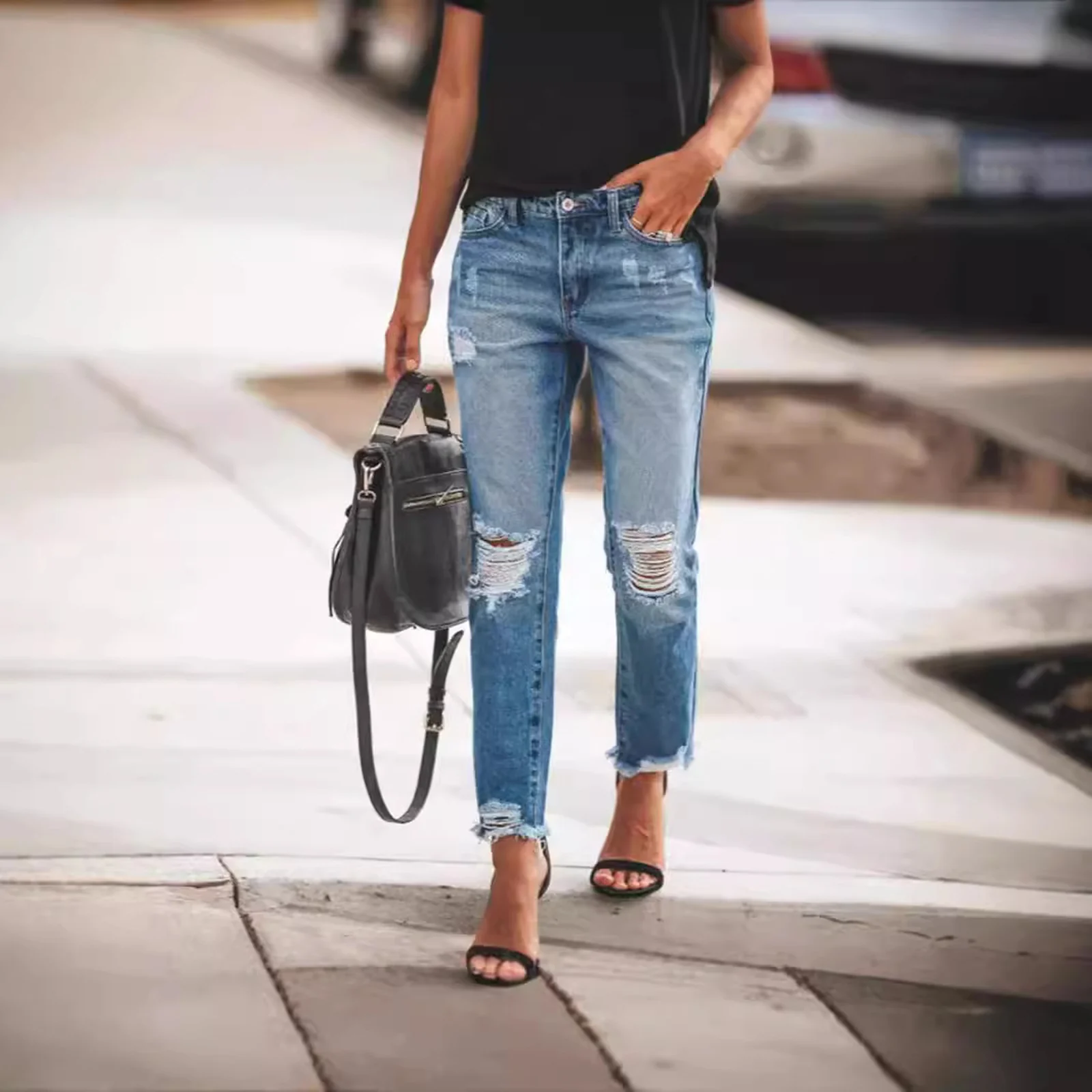 The Dark Wash distressed jeans worn with heels