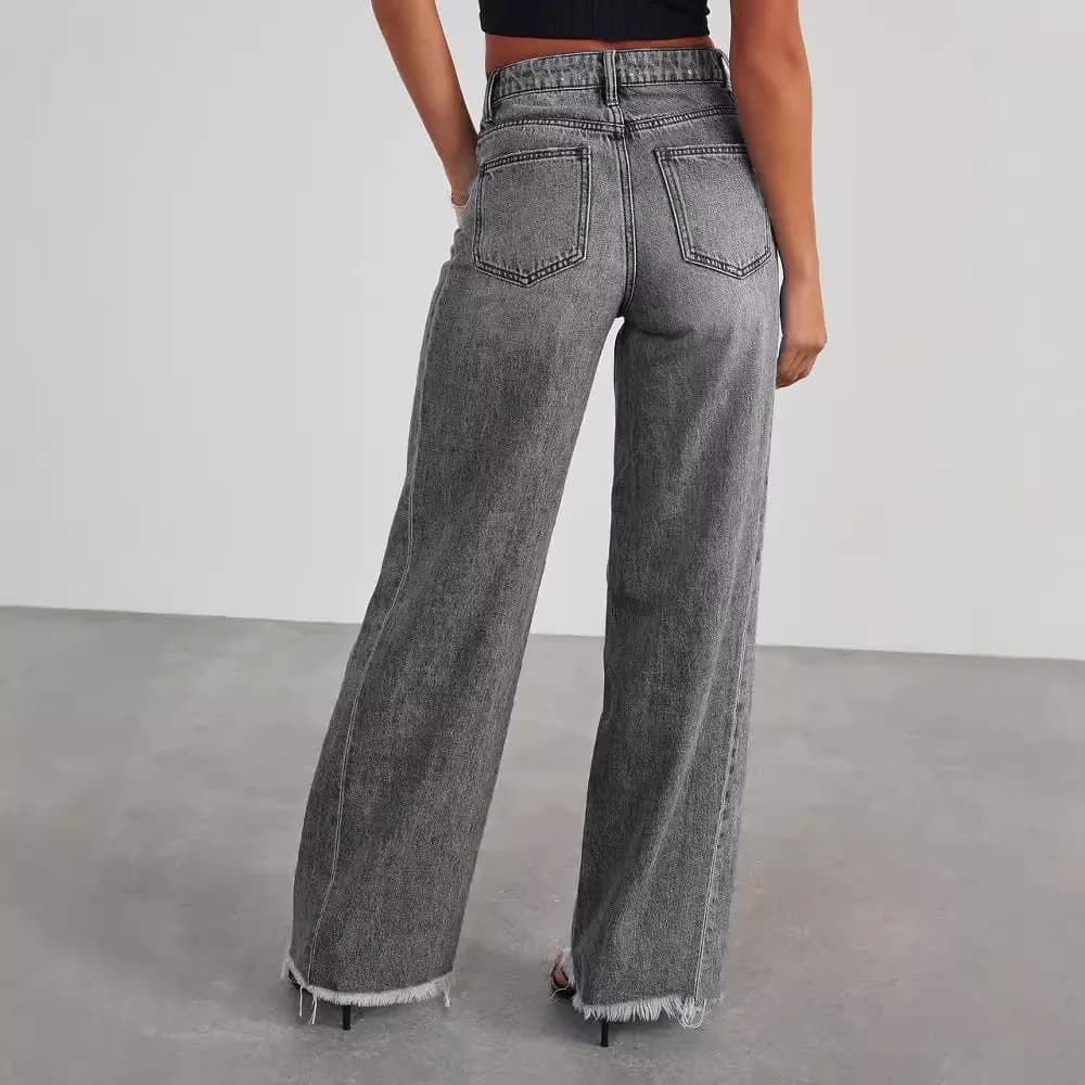 A person wearing high-waist wide-leg grey jeans with a frayed hem, viewed from the back