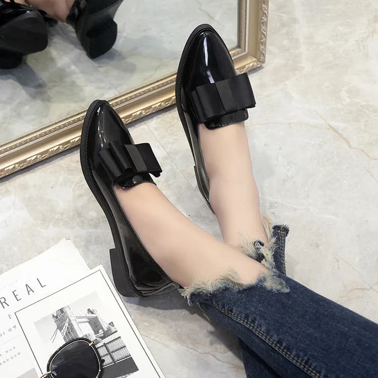Patent Bow Pointed Flats in Black, worn by a model