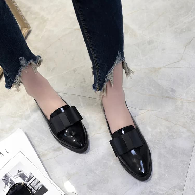 Patent Bow Pointed Flats in Black, worn by a model
