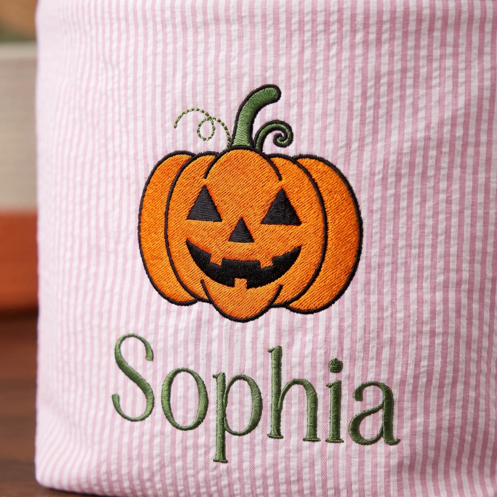 Close-up of the embroidered pumpkin and name