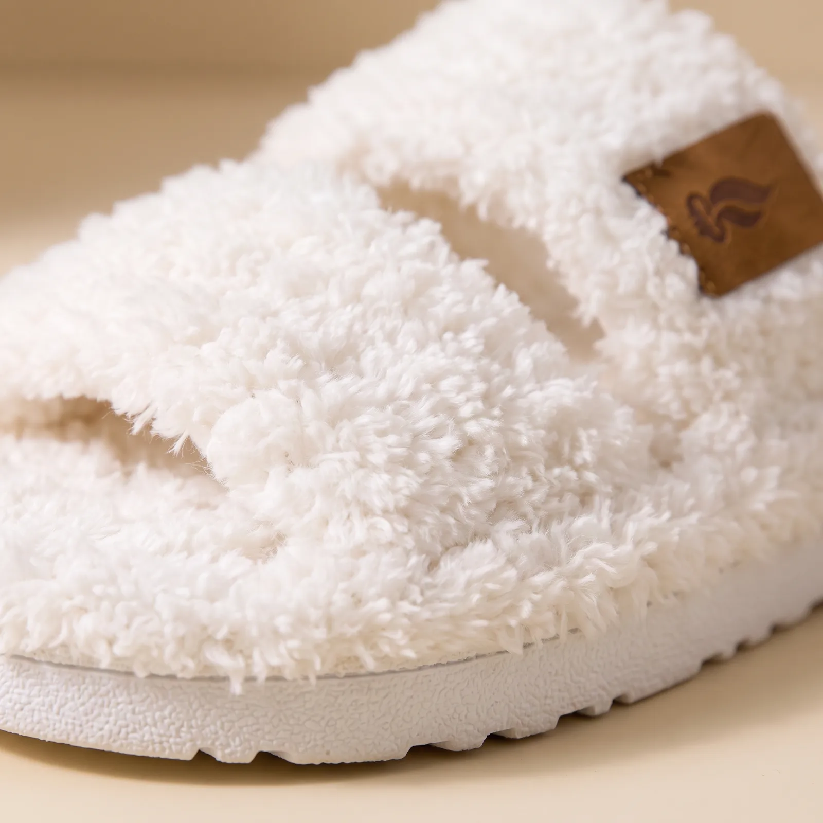 Close-up of the two wide plush straps and thick outsole