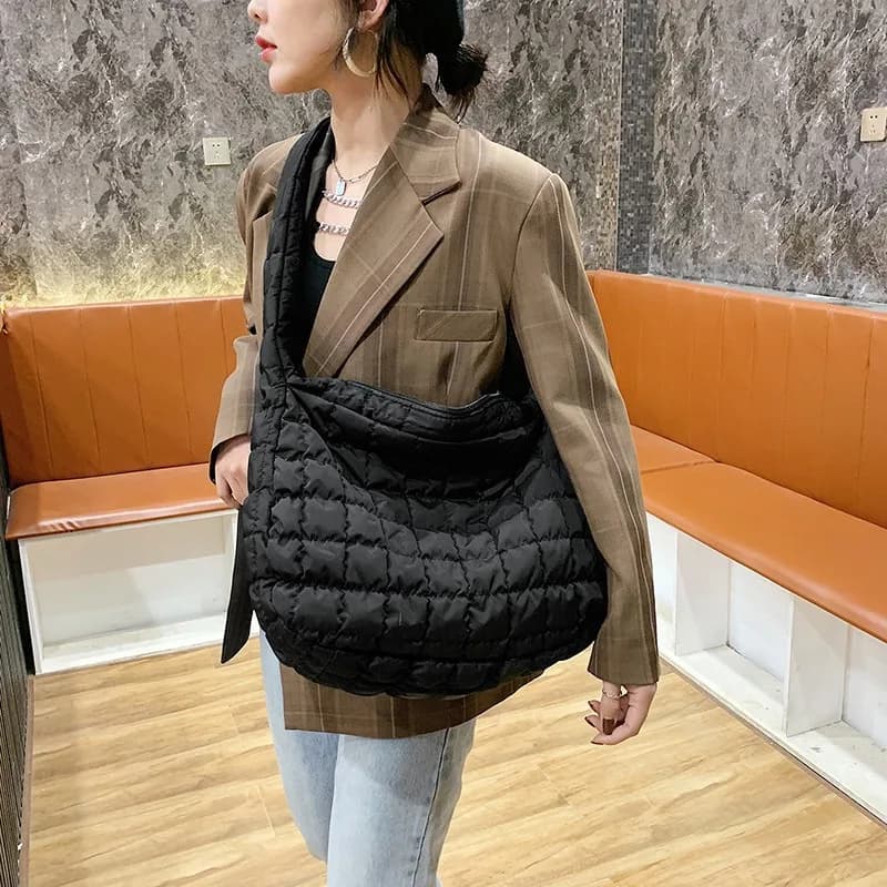 Puffer Quilted Tote in Black, worn by a model
