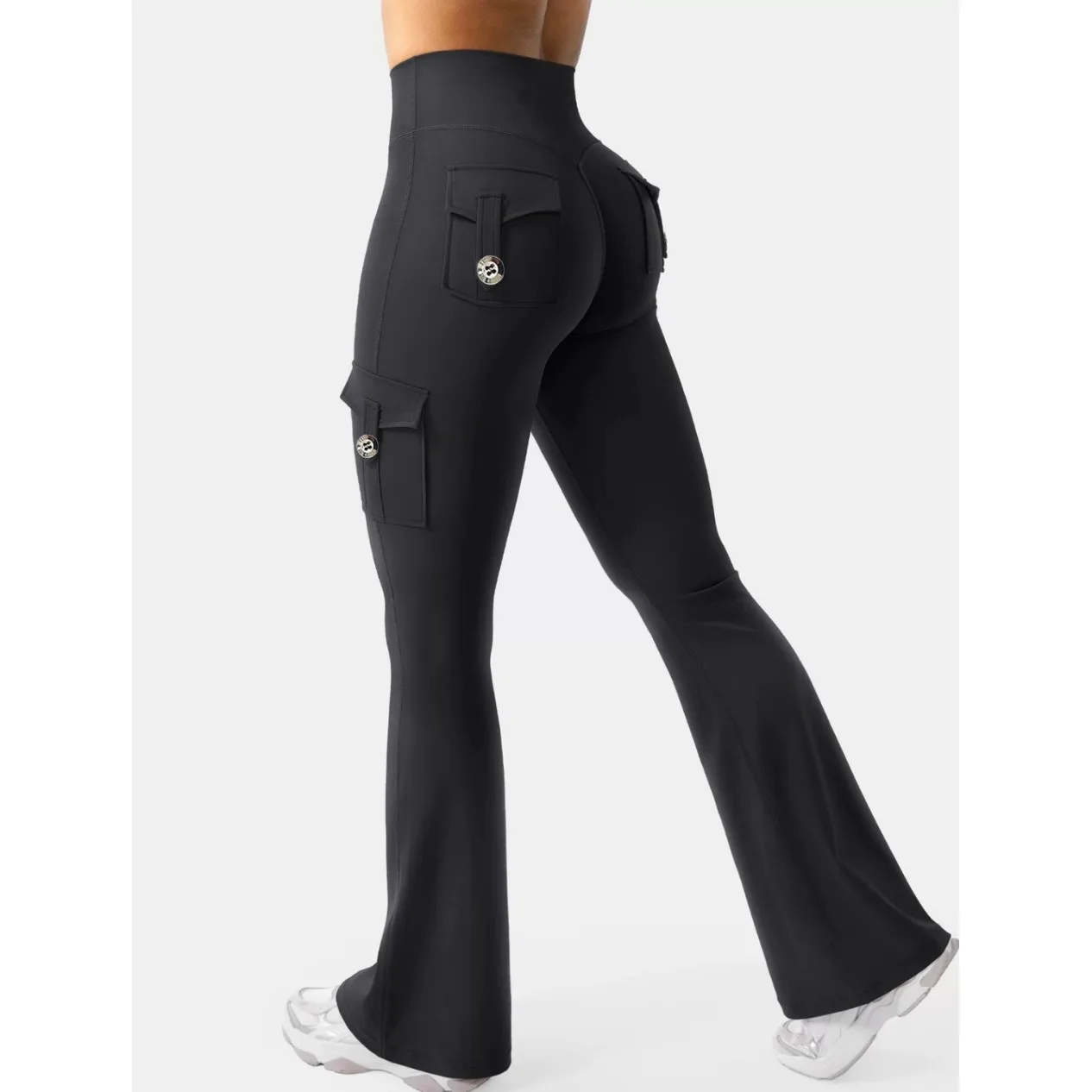 A side view of a person wearing black pull-on bootcut dress pants with cargo pockets
