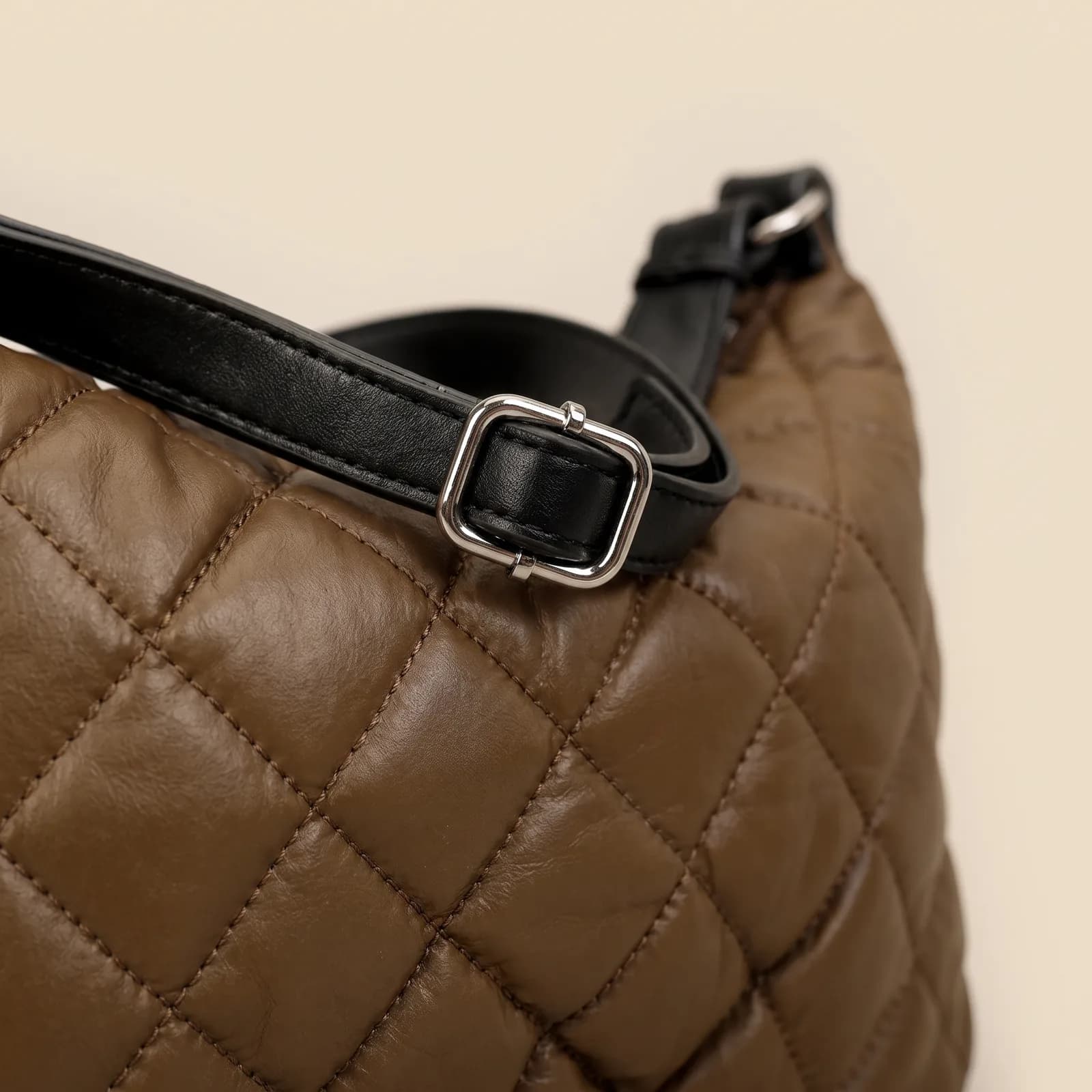 Close-up of the diamond quilting and the adjustable strap hardware