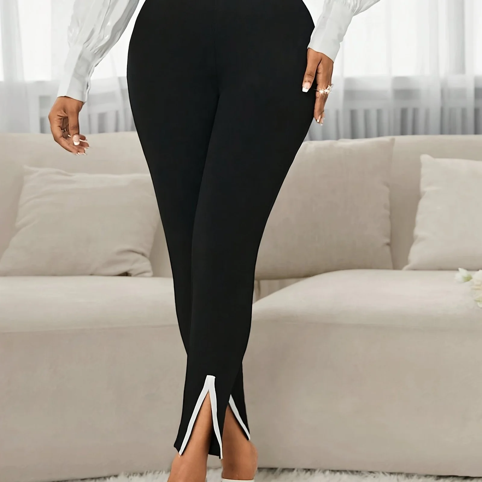 The Black slim work pants, close view of the split hem