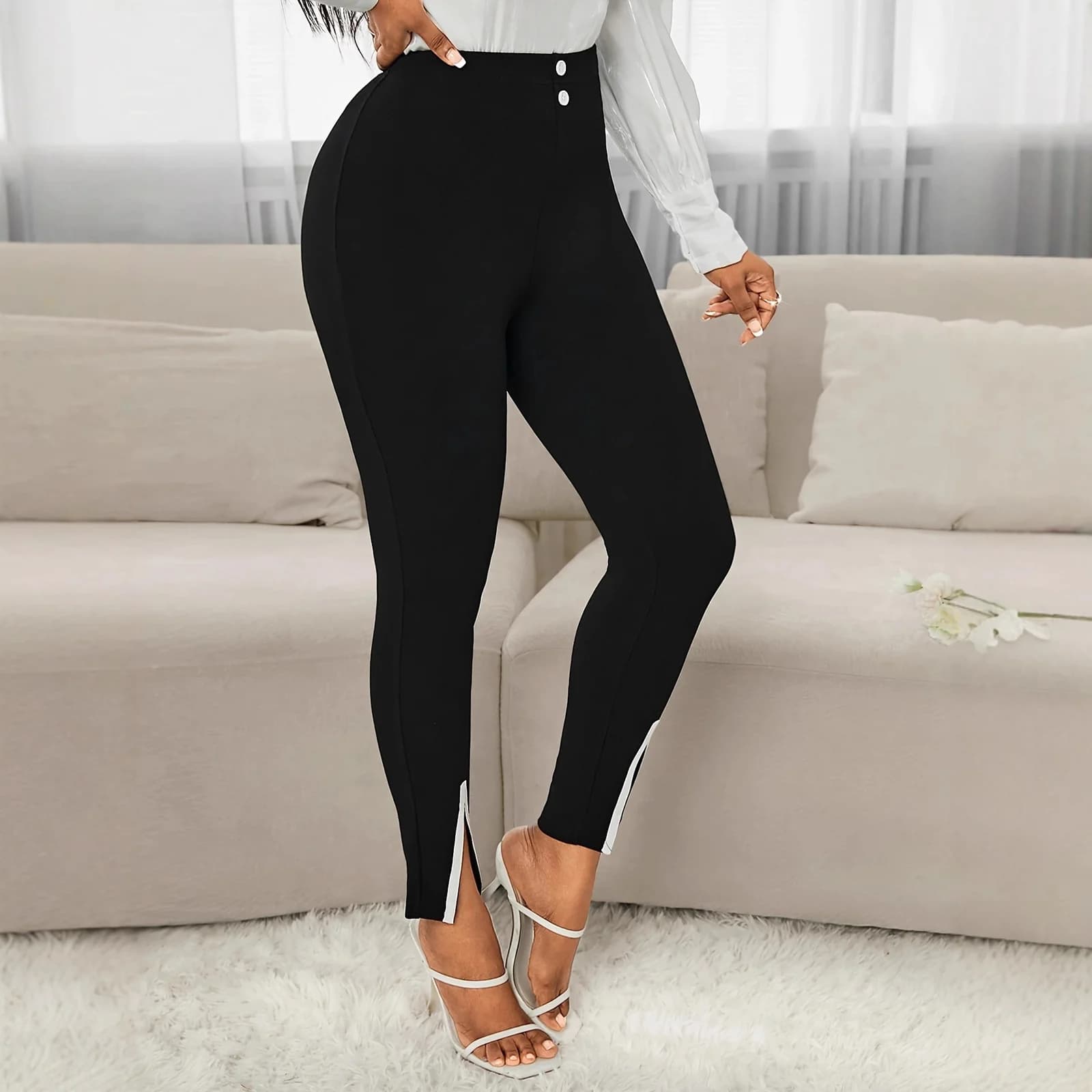 The Black slim work pants worn with heels, front view