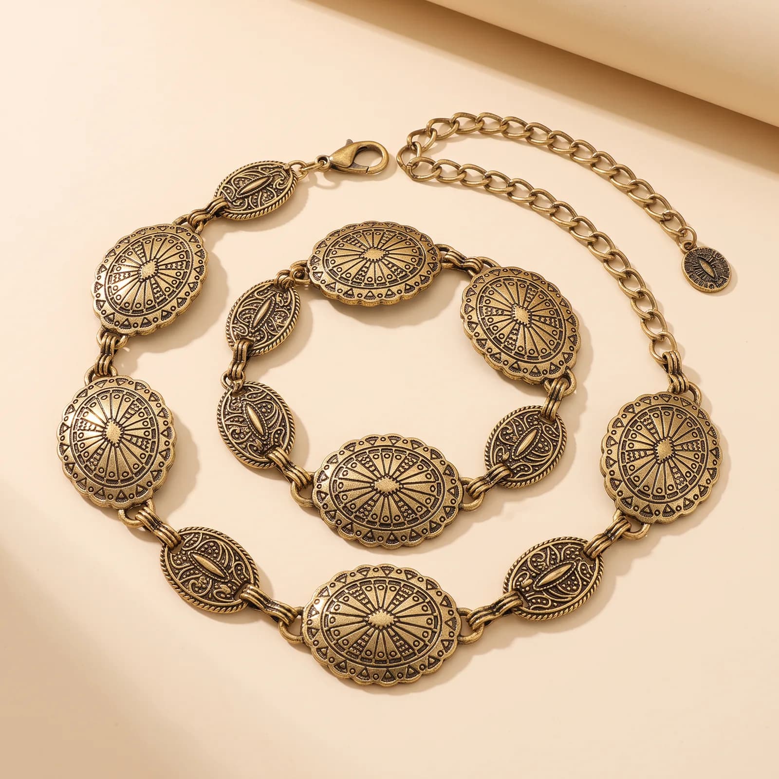 Western Concho Chain Belt in Antique Gold on a cream studio background
