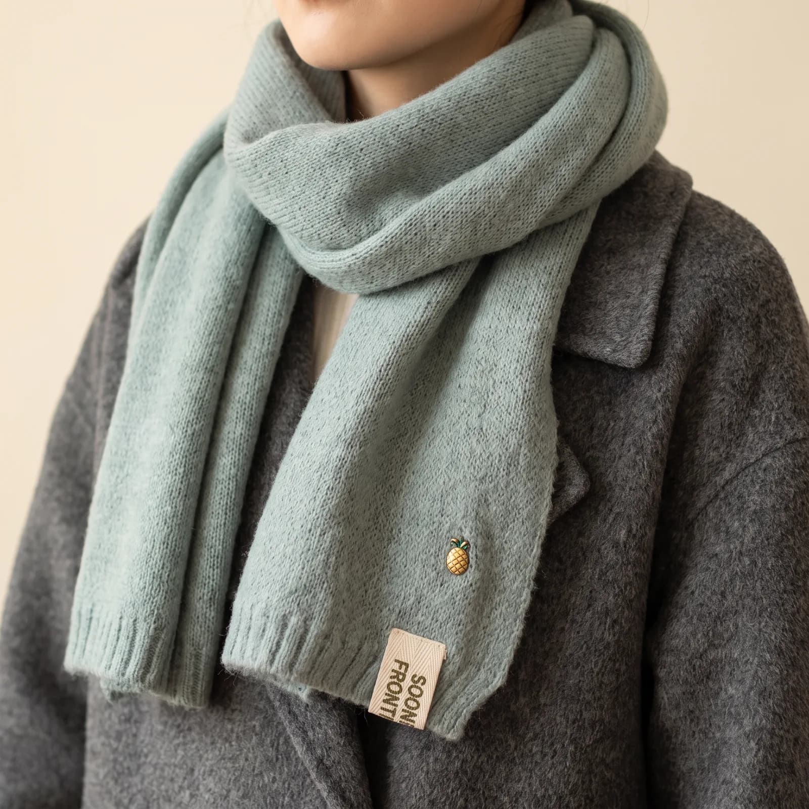 A scarf wrapped around the neck and shoulders over a coat, no face
