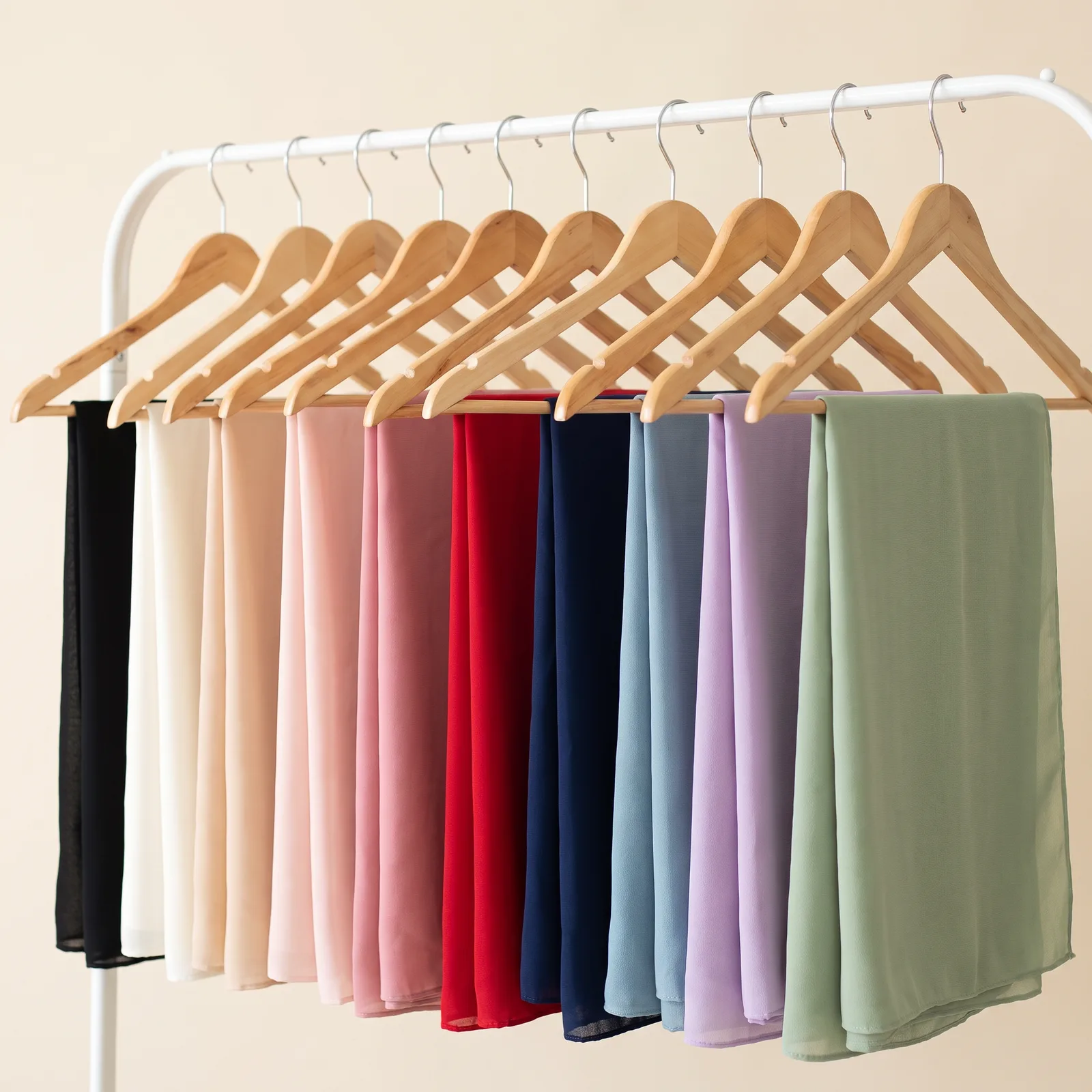 Black, Ivory, Champagne, Blush, Rose, Red, Navy, Dusty Blue, Lavender, and Sage shawls lined up side by side