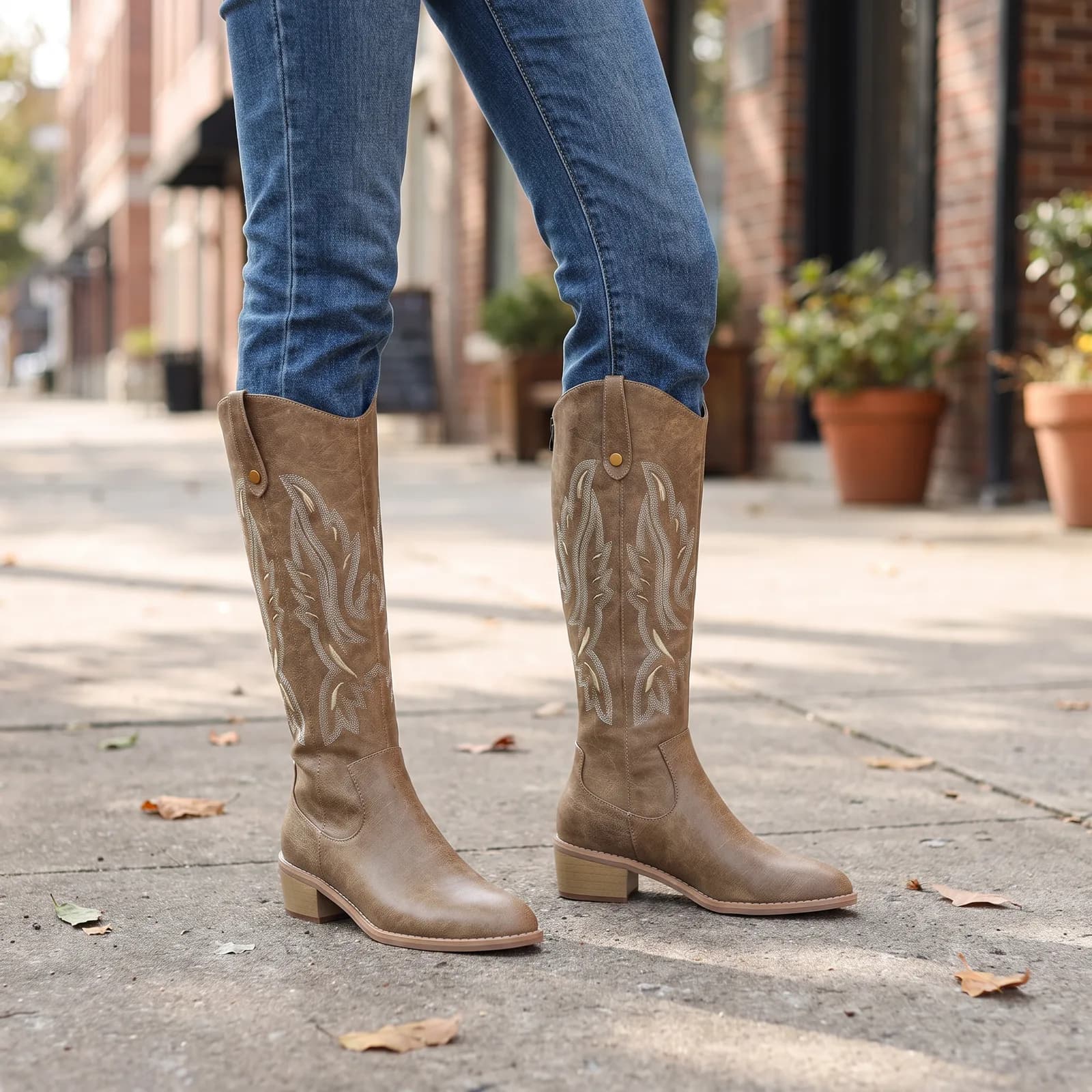 Legs from the knee down wearing the chunky-heel western boots with straight-leg jeans