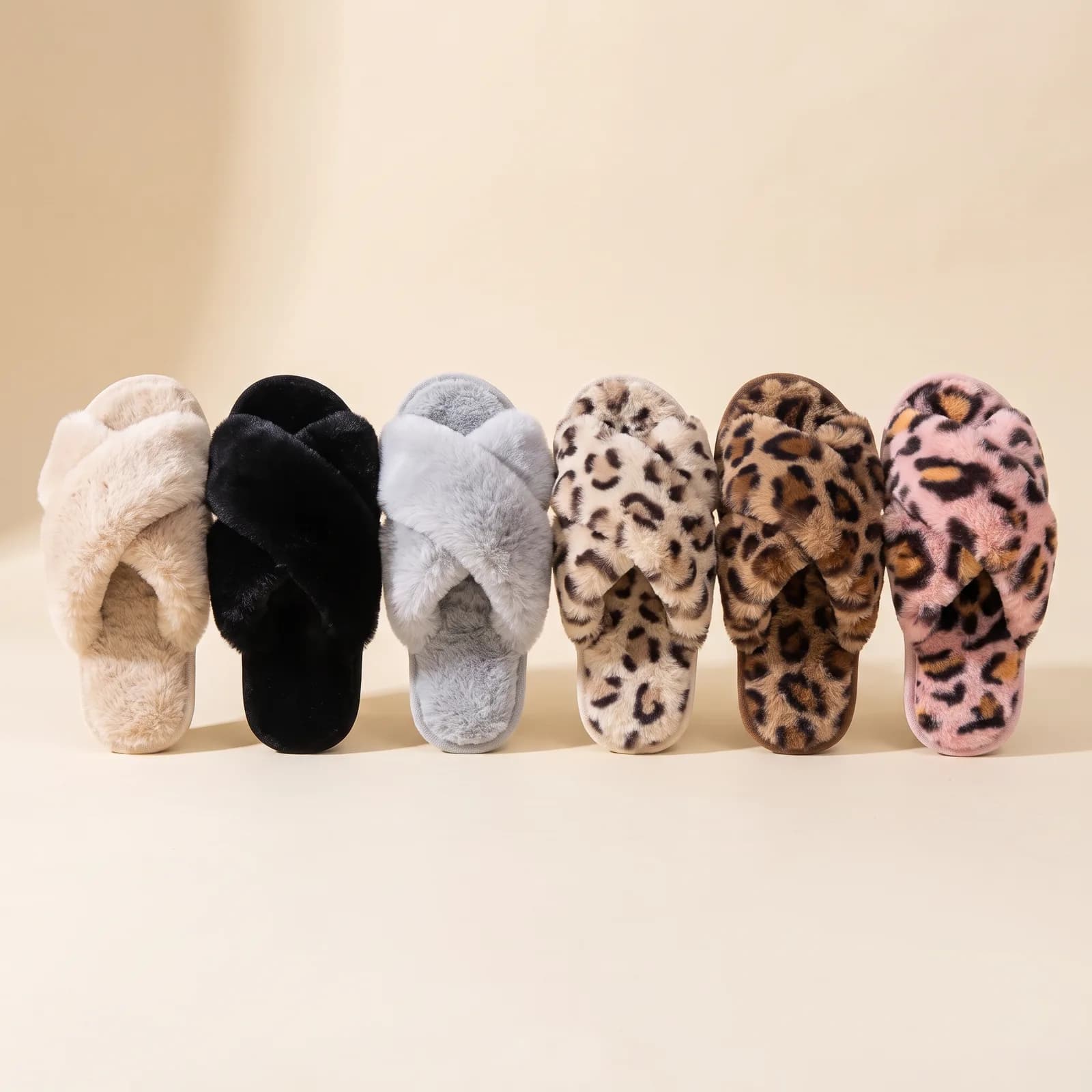 Oat, Black, Cloud Grey, Beige Leopard, Brown Leopard, and Pink Leopard slippers lined up side by side