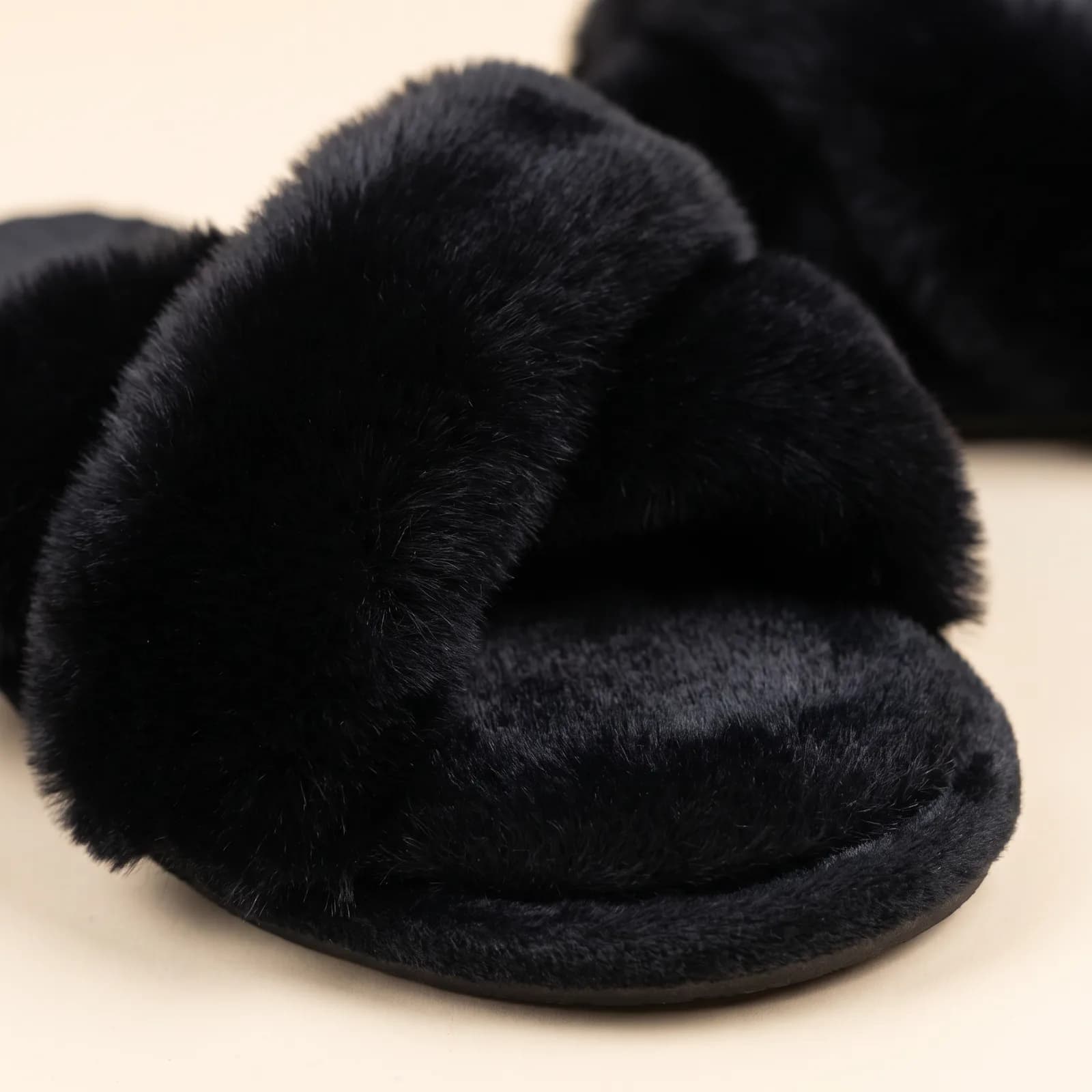 Close-up of the crisscross faux fur strap and cushioned footbed