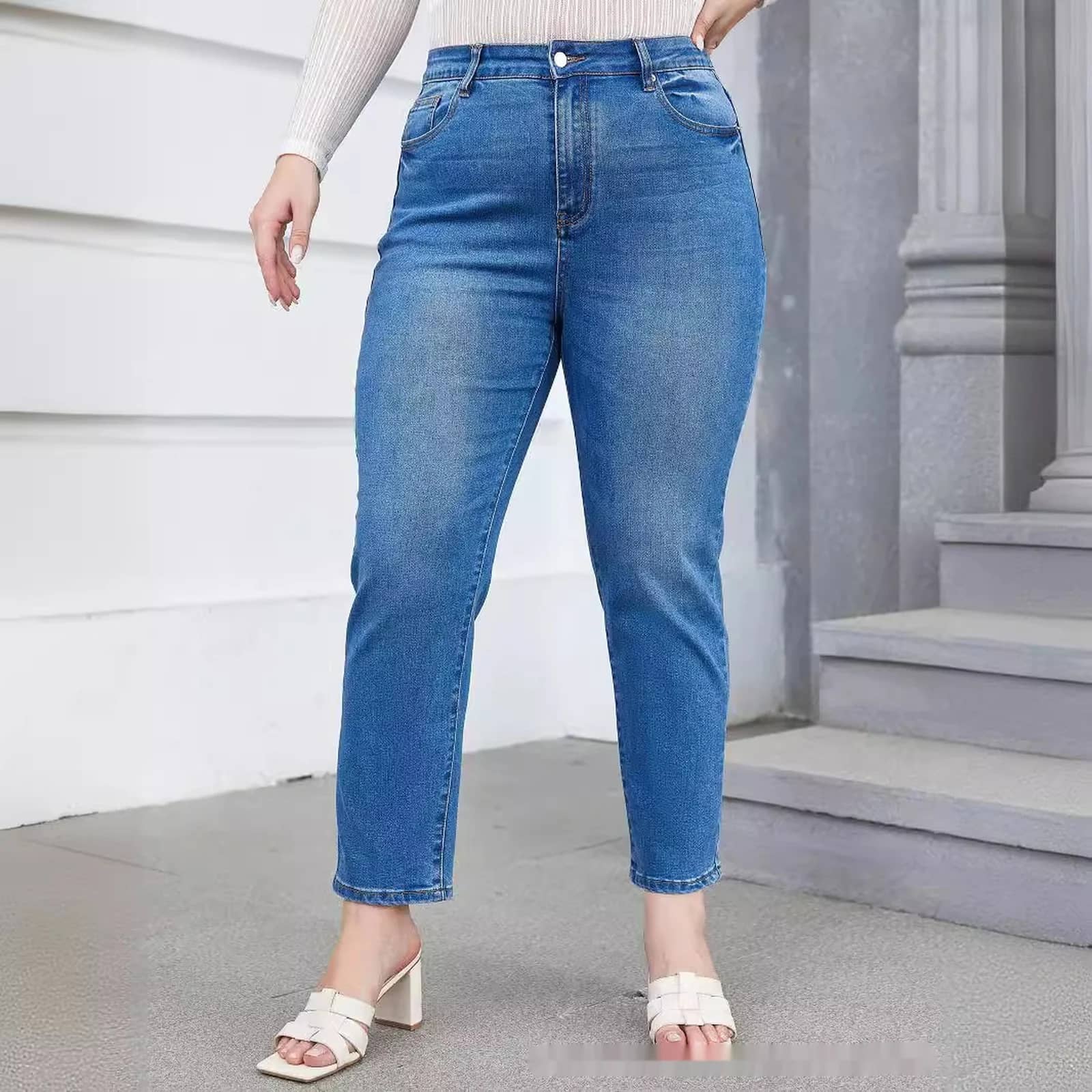 Curvy Tapered Mom Jeans in Medium Wash worn full length with a white top