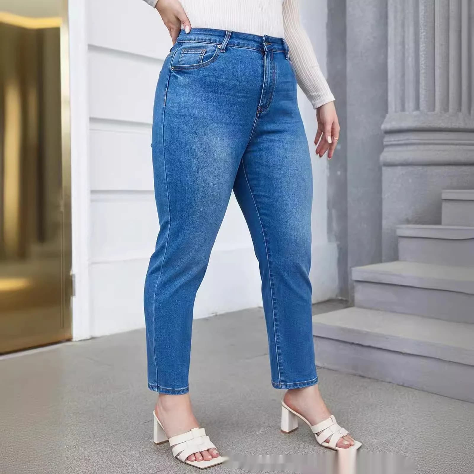 The curvy tapered mom jeans worn with heels, side view