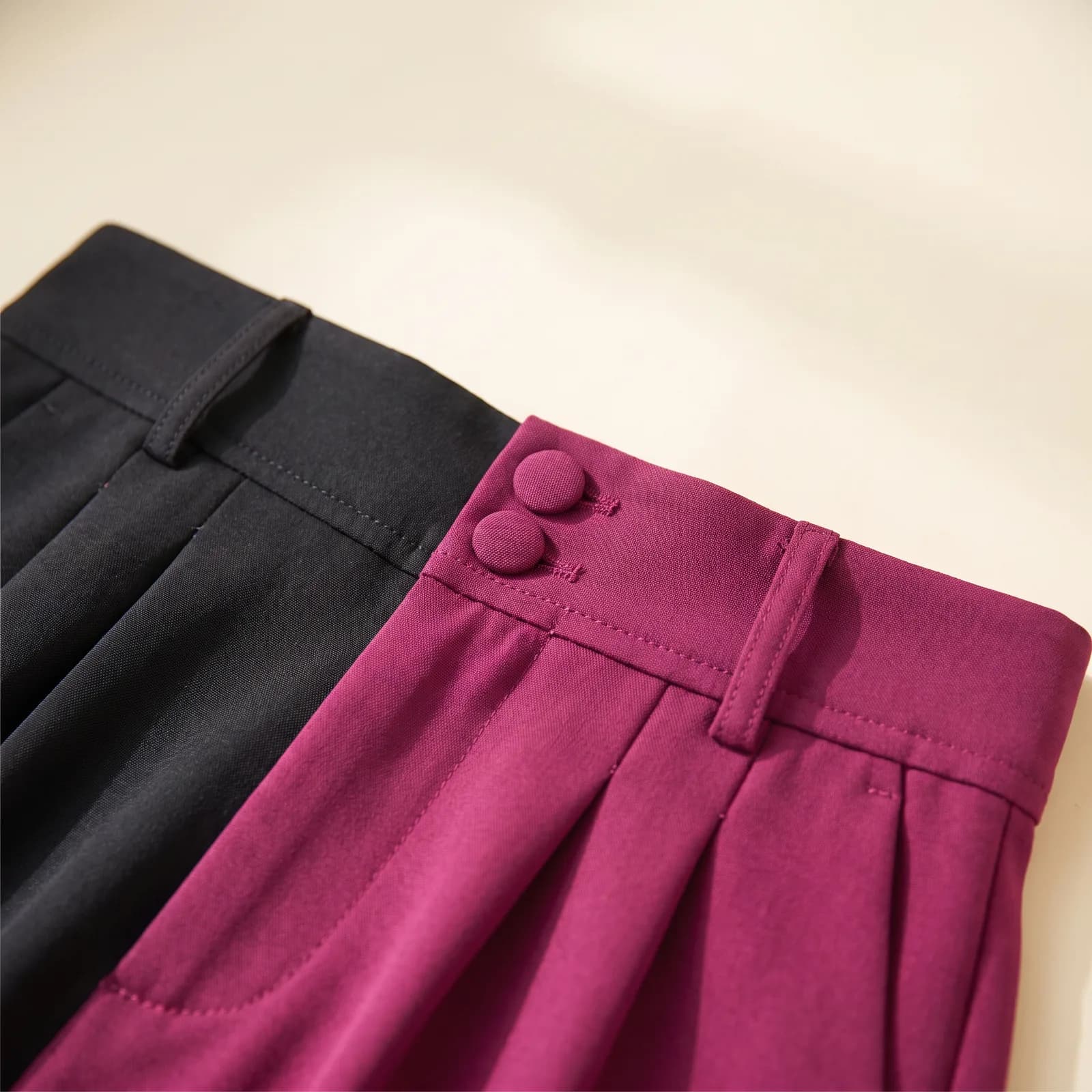 Close-up of the pressed front pleats and button waistband