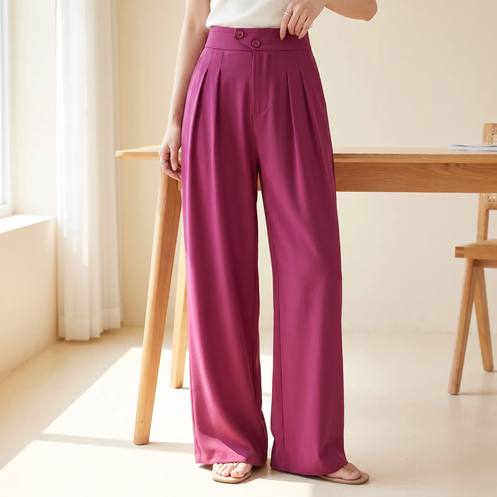 Legs and waist wearing the drape trousers, standing in a studio