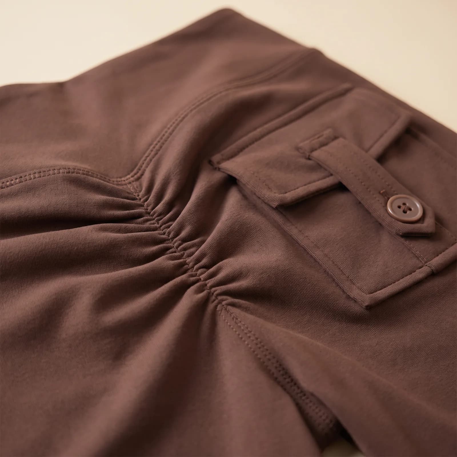 Close-up of the scrunch back seam and buttoned back pocket