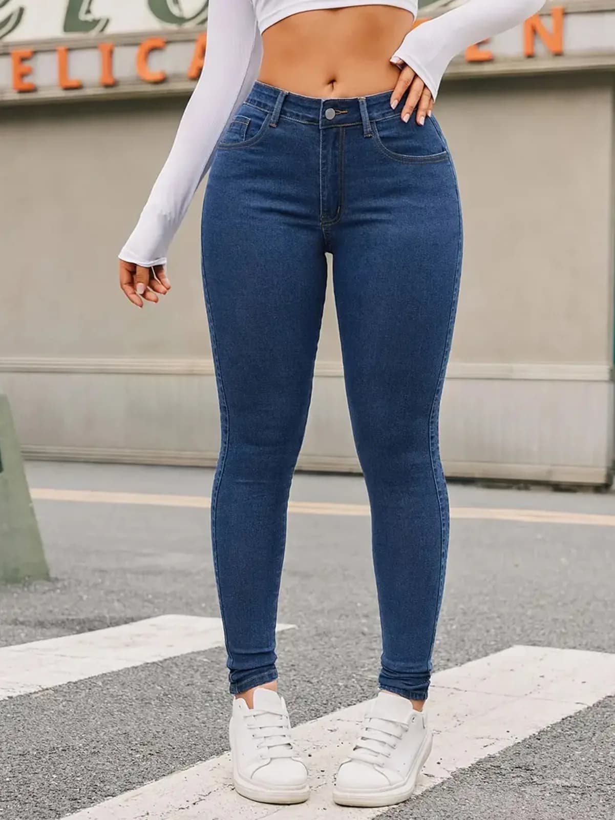 High-Rise Skinny Jeans in Medium Wash, worn by a model