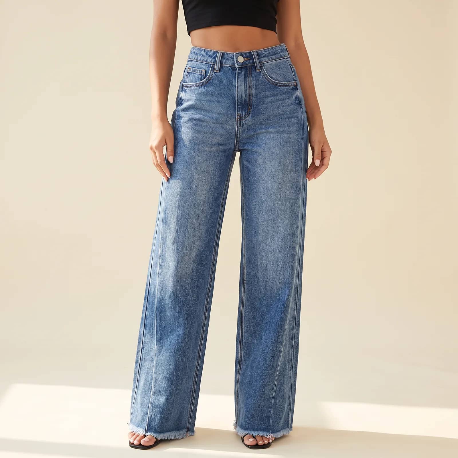 High-Waist Wide-Leg Jeans in Medium Wash on a cream studio background