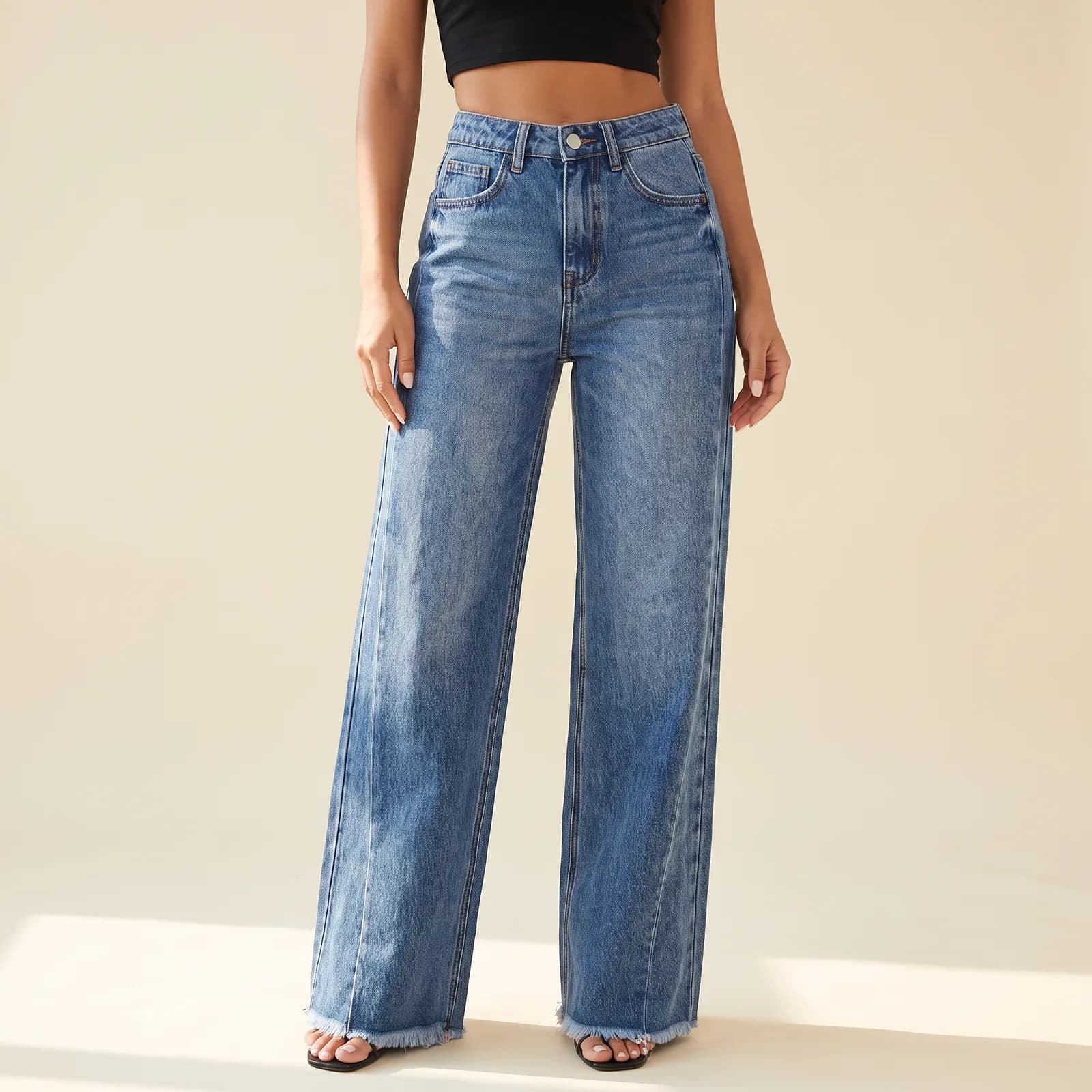 High-Waist Wide-Leg Jeans in Medium Wash on a cream studio background