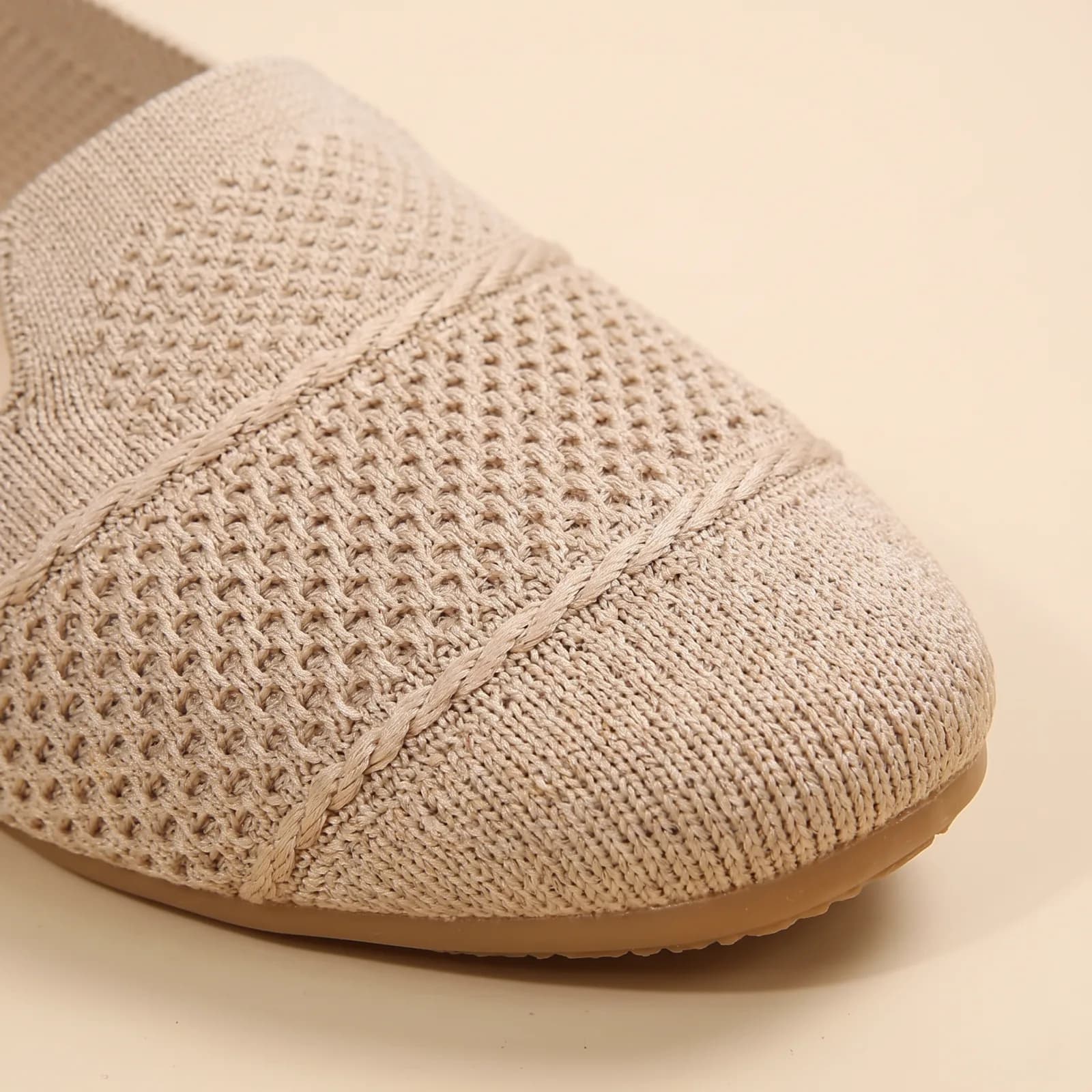 Close-up of the stretch-knit texture and round toe seam