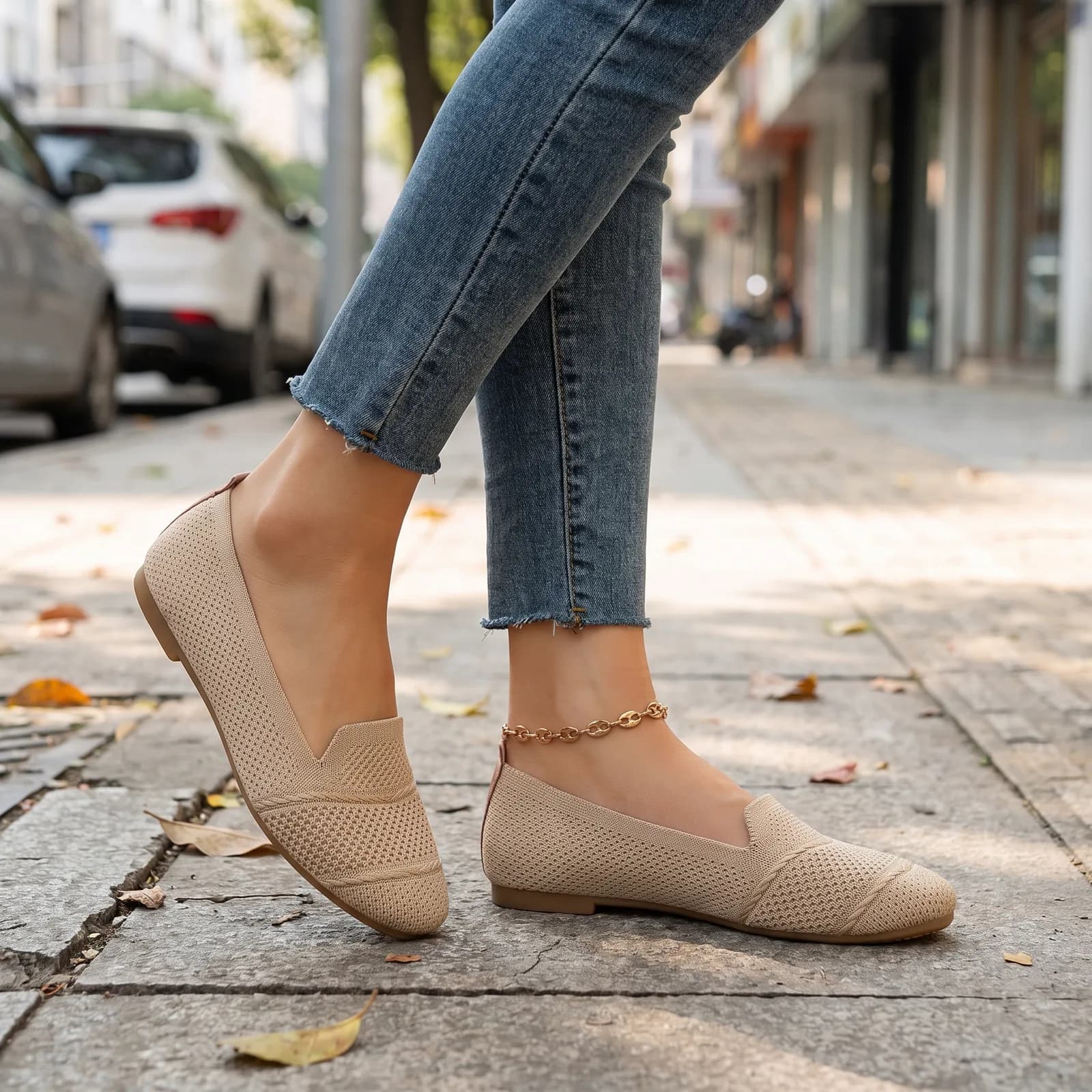 Feet from the ankle down wearing the knit ballet flats with cropped denim