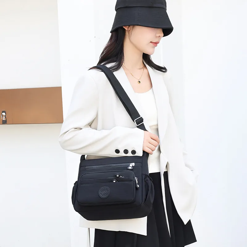 Lightweight Nylon Crossbody in Black, worn by a model