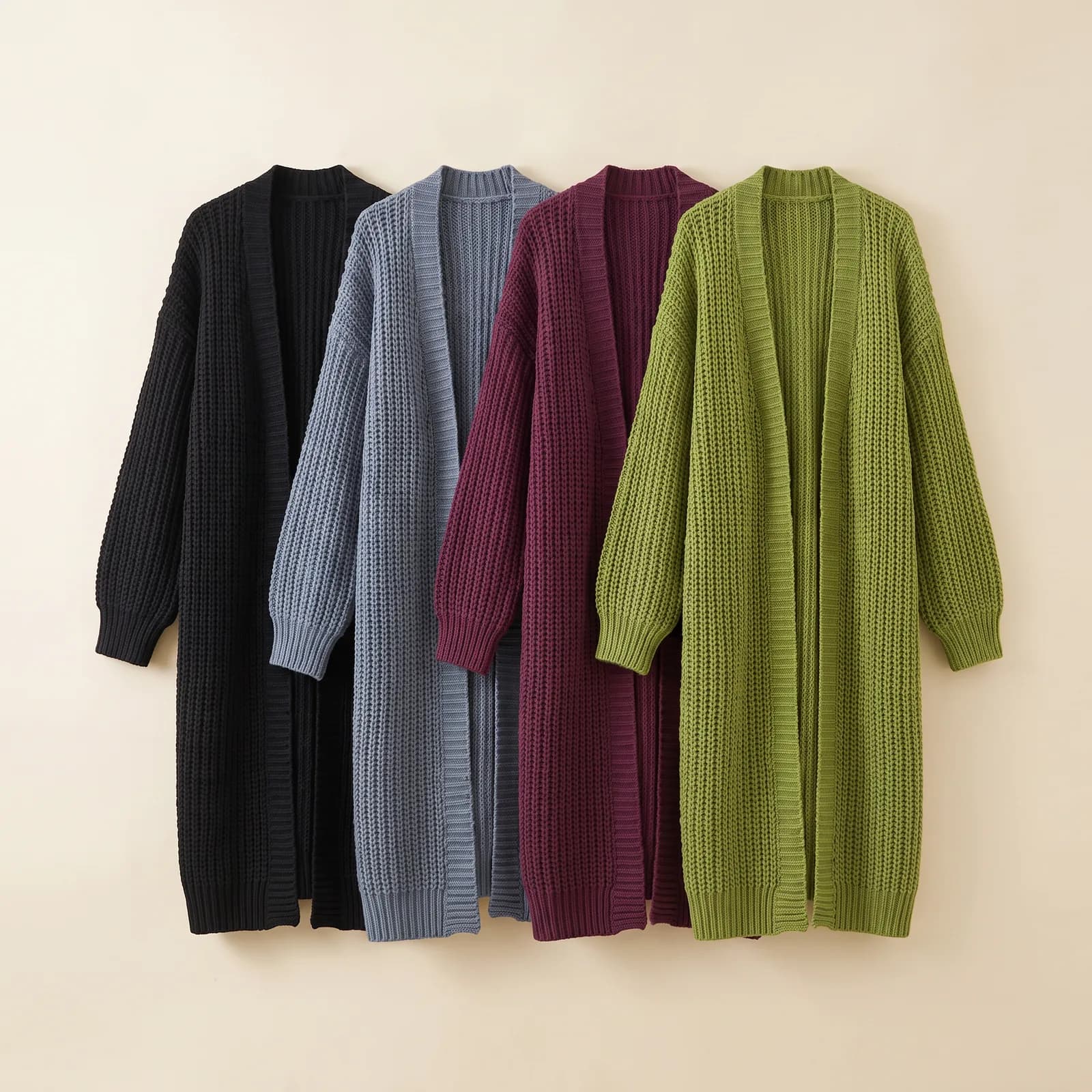 Black, Blue Grey, Plum, and Grass cardigans lined up side by side