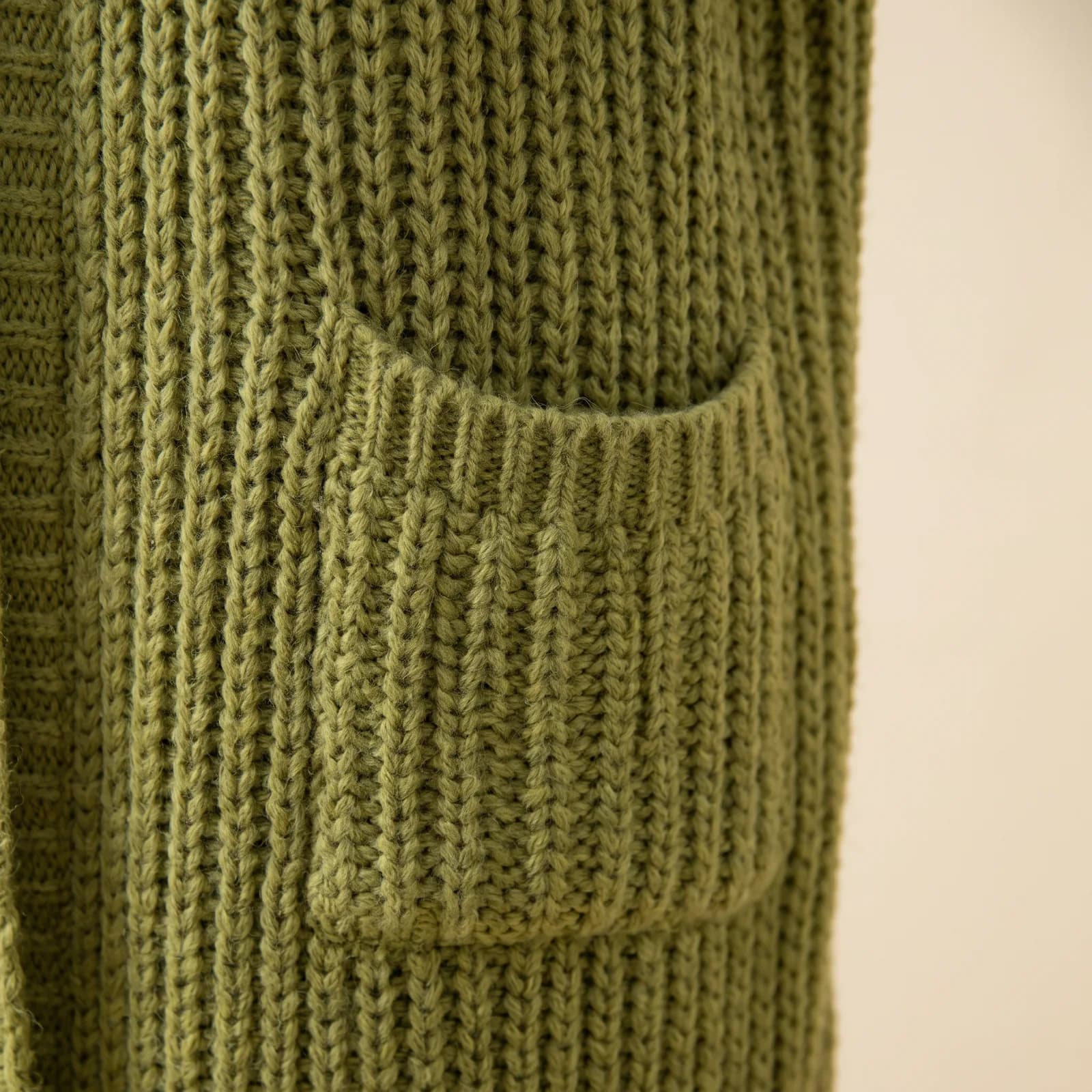 Close-up of the ribbed knit texture and a patch pocket