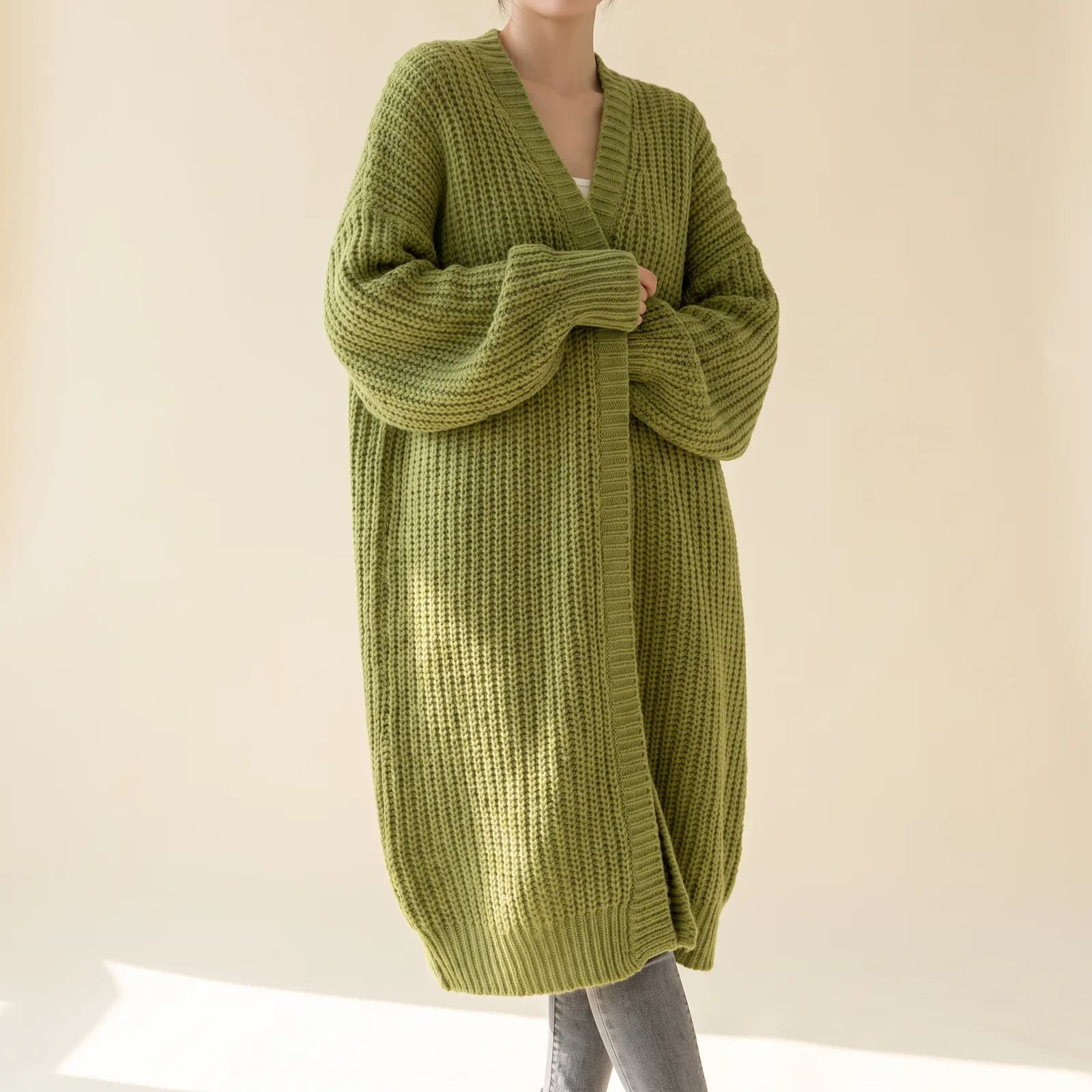 Longline Pocket Knit Cardigan in Grass on a cream studio background
