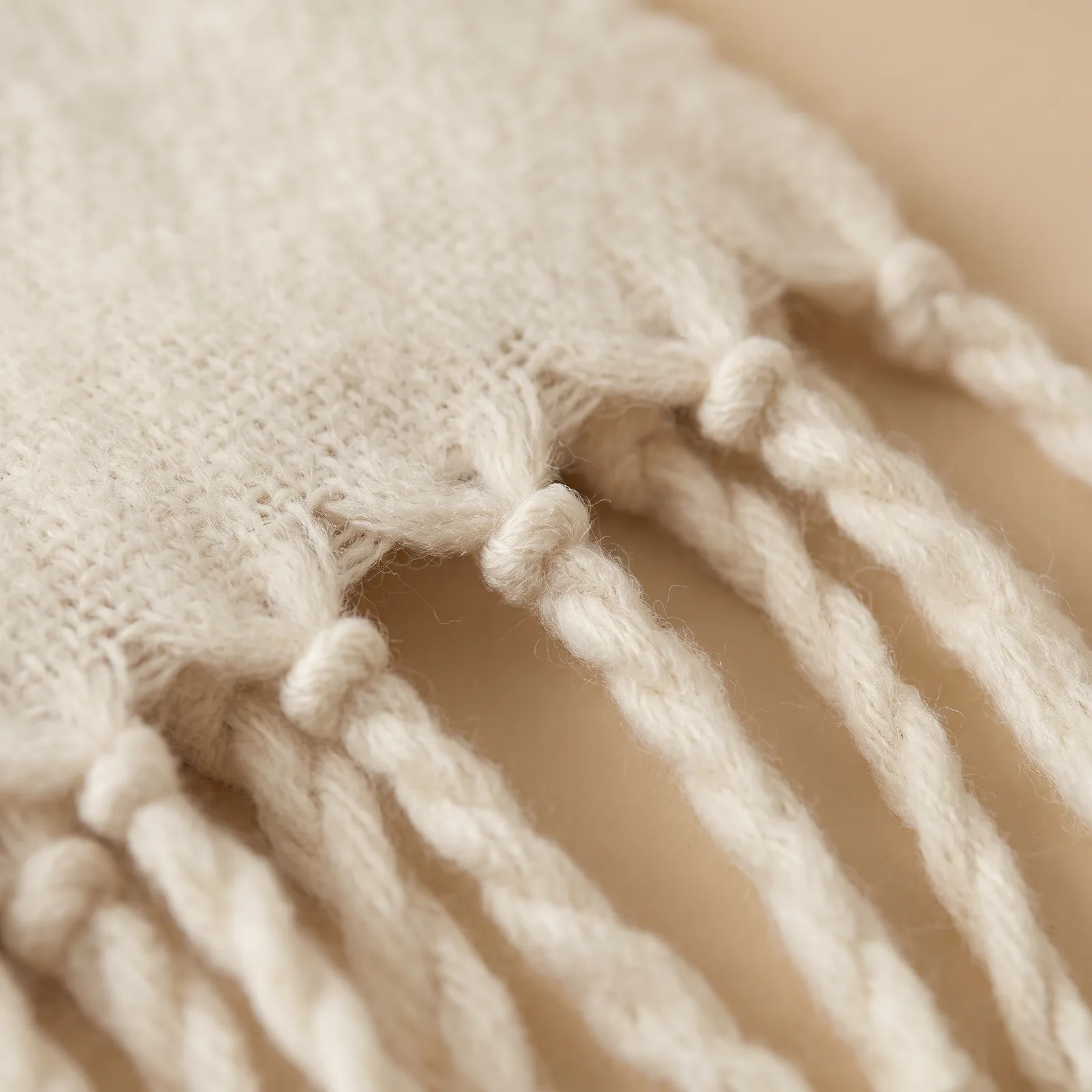Close-up of the knotted tassel fringe and the weave texture
