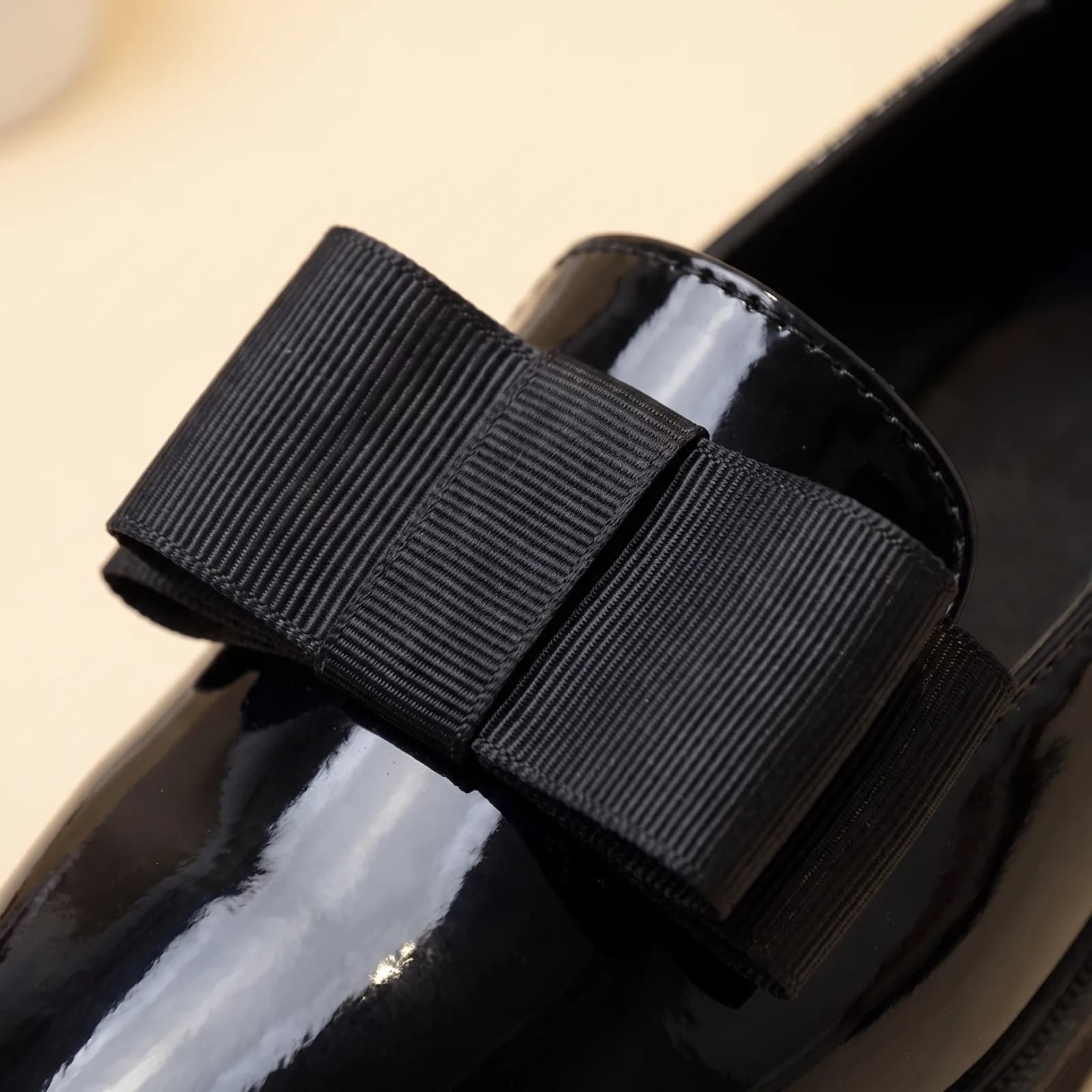 Close-up of the grosgrain bow and glossy patent finish