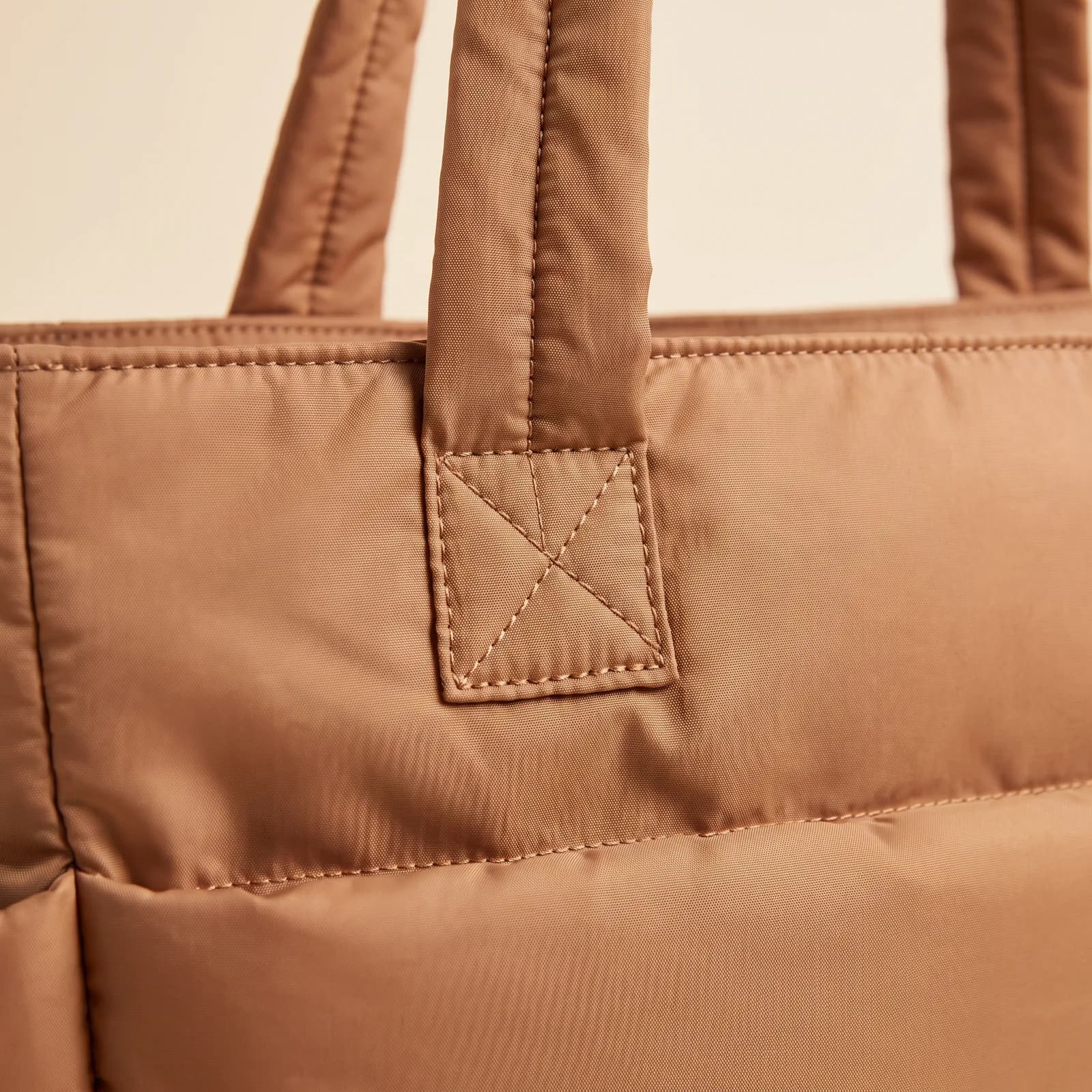 Close-up of the quilted horizontal channels and a padded strap