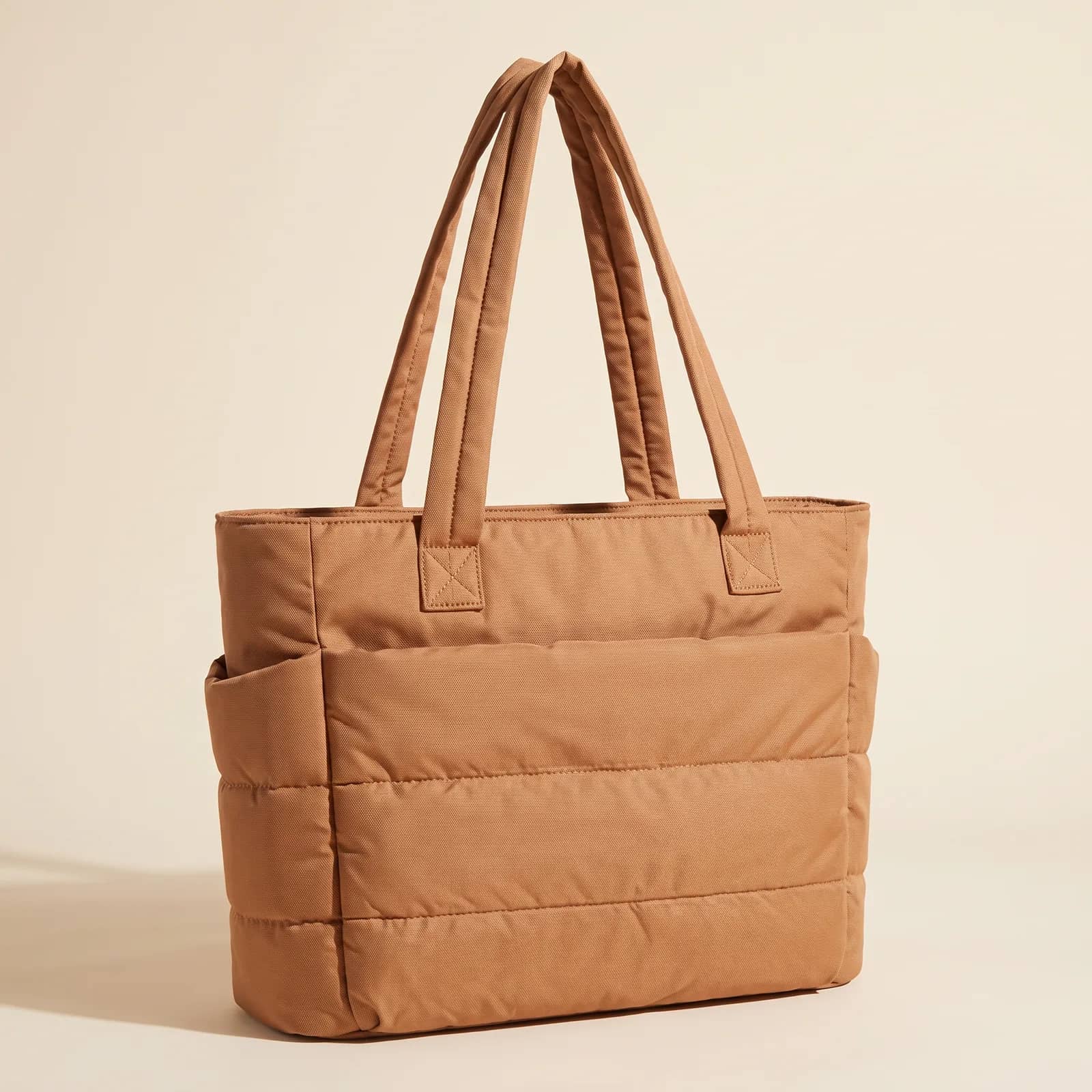 Puffer Laptop Tote in Camel on a cream studio background