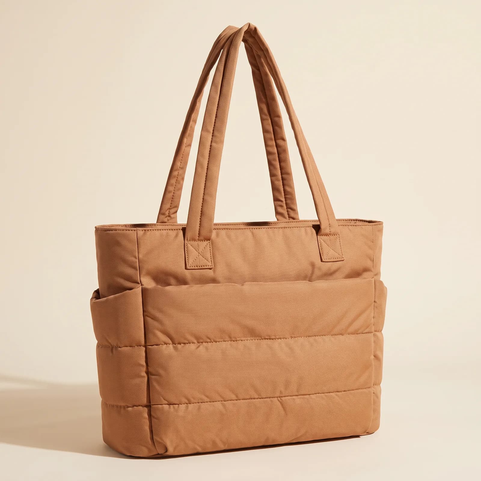 Puffer Laptop Tote in Camel on a cream studio background