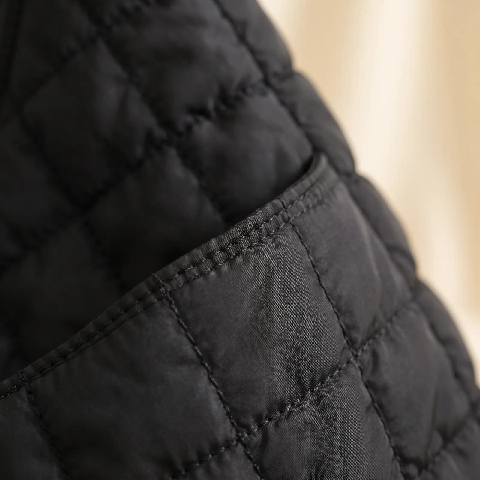 Close-up of the diamond quilting and the front slip pocket
