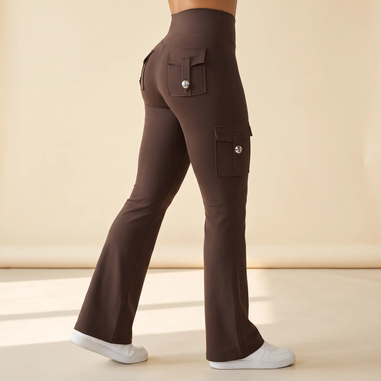 Legs from the waist down wearing the bootcut pants, standing in a studio