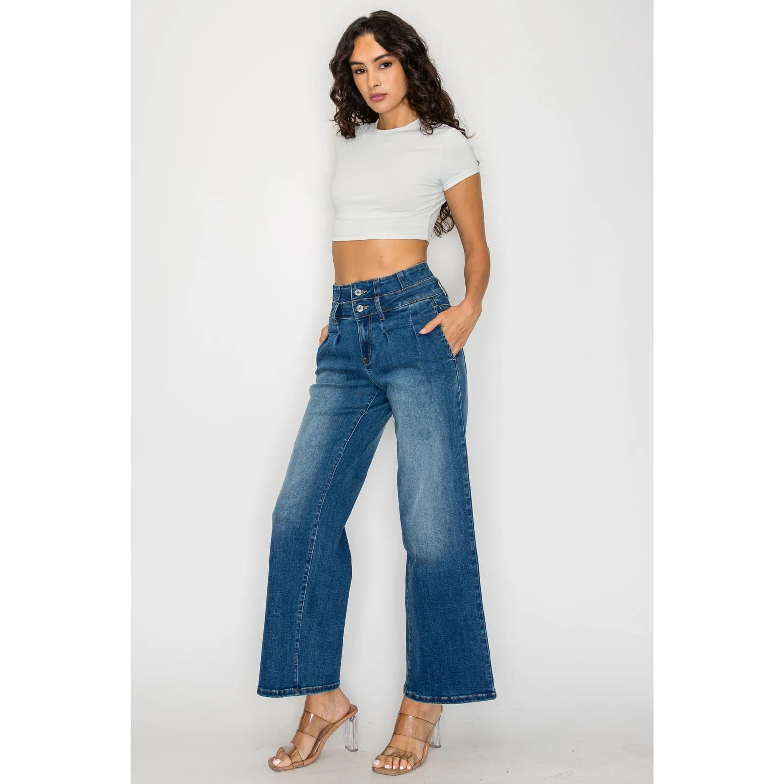 The cropped wide-leg jeans worn with a white top, standing