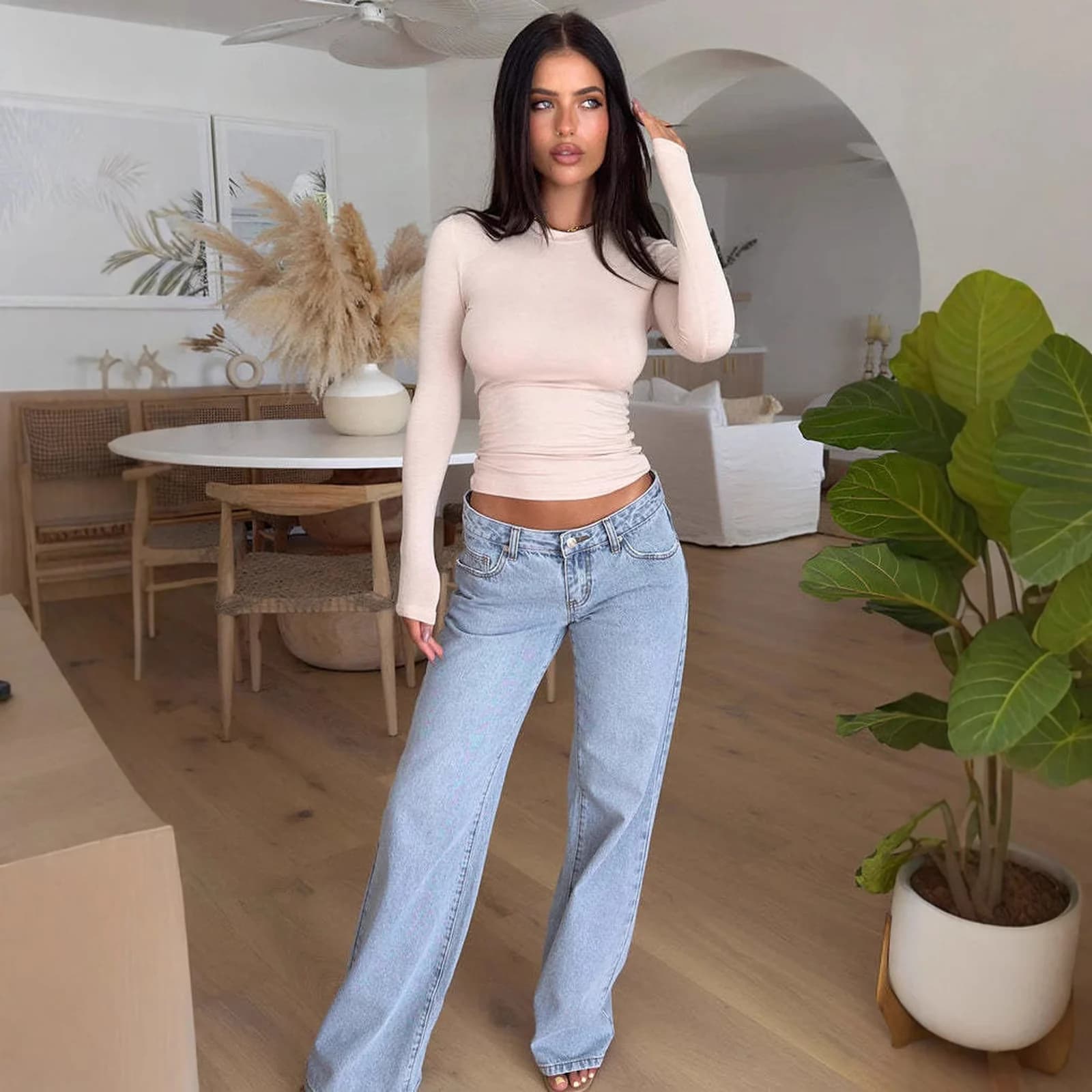 The Light Wash relaxed straight jeans worn in a bright living room