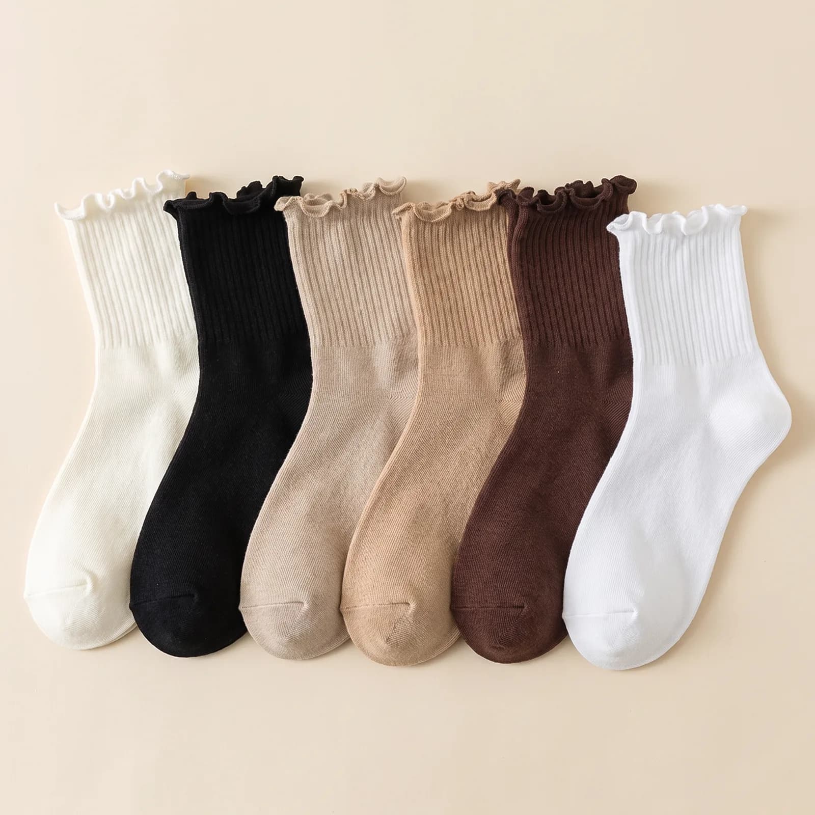 Milk White, Black, Oat, Khaki, Coffee, and Bright White socks lined up side by side