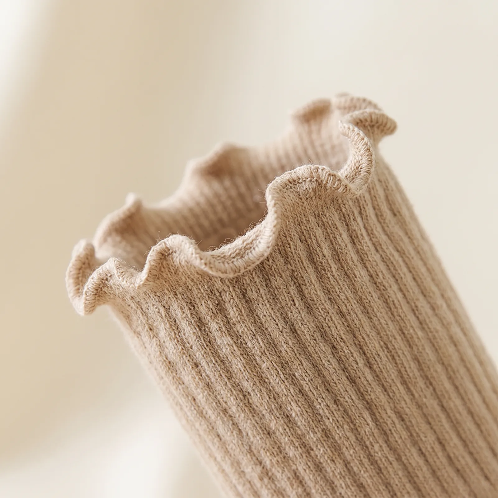 Close-up of the ruffled cuff trim and the ribbed ankle knit