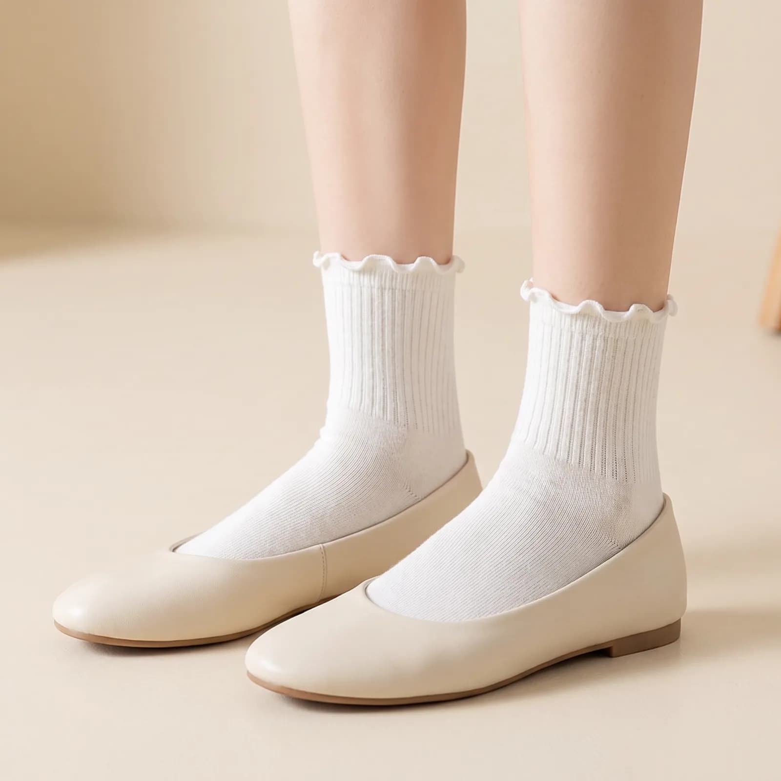 A woman's feet from the ankle down wearing ruffle socks with flats, no face