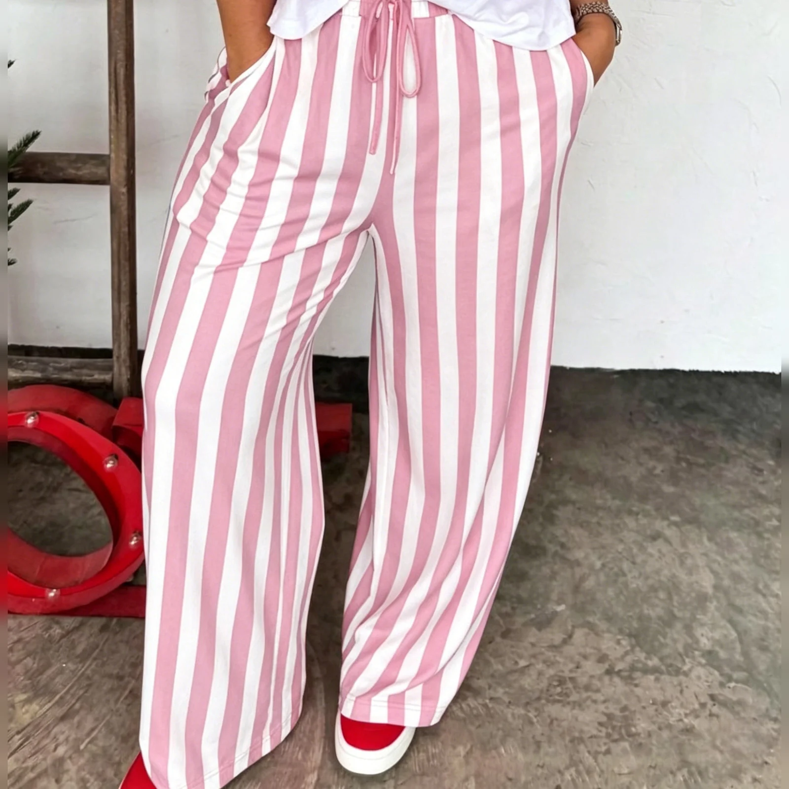 The Blush Stripe palazzo pants worn with a white tee