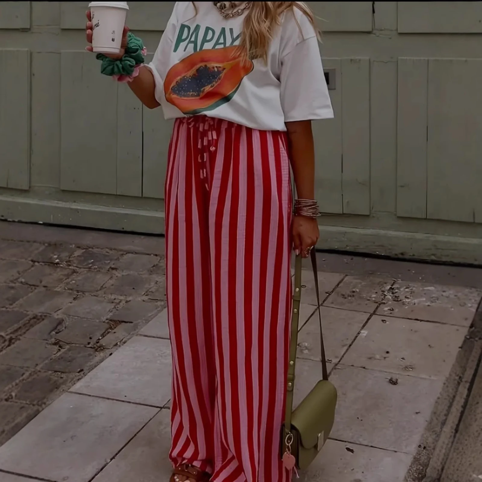 The Red Stripe palazzo pants worn full length, walking
