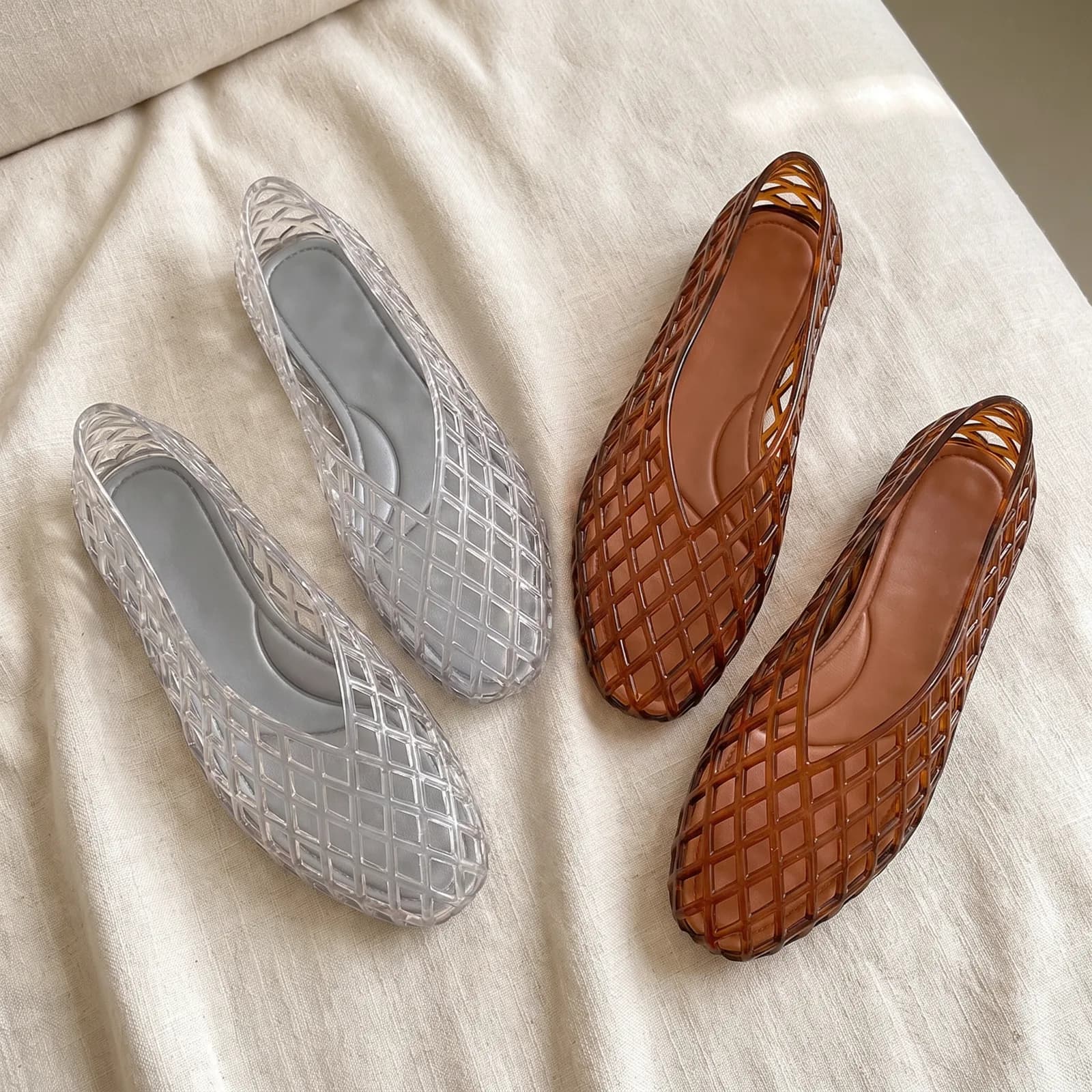 Both flats laid top-down on warm cream linen showing the lattice pattern